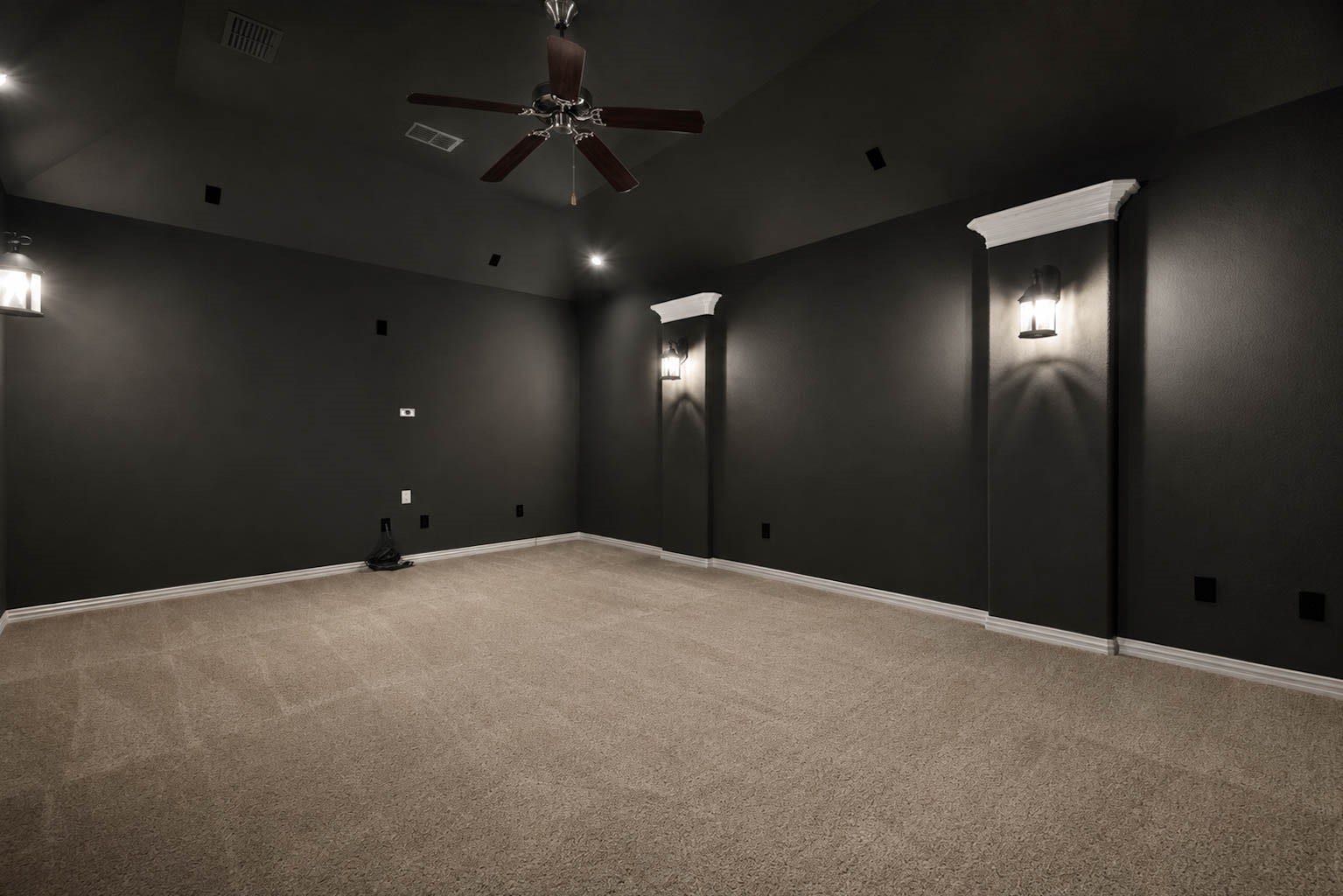 3814 Bluffstone Court, Sugar Land, TX 77479 Dedicated media room with dramatic dark walls, vaulted ceiling, accent lighting and prewired entertainment setup.