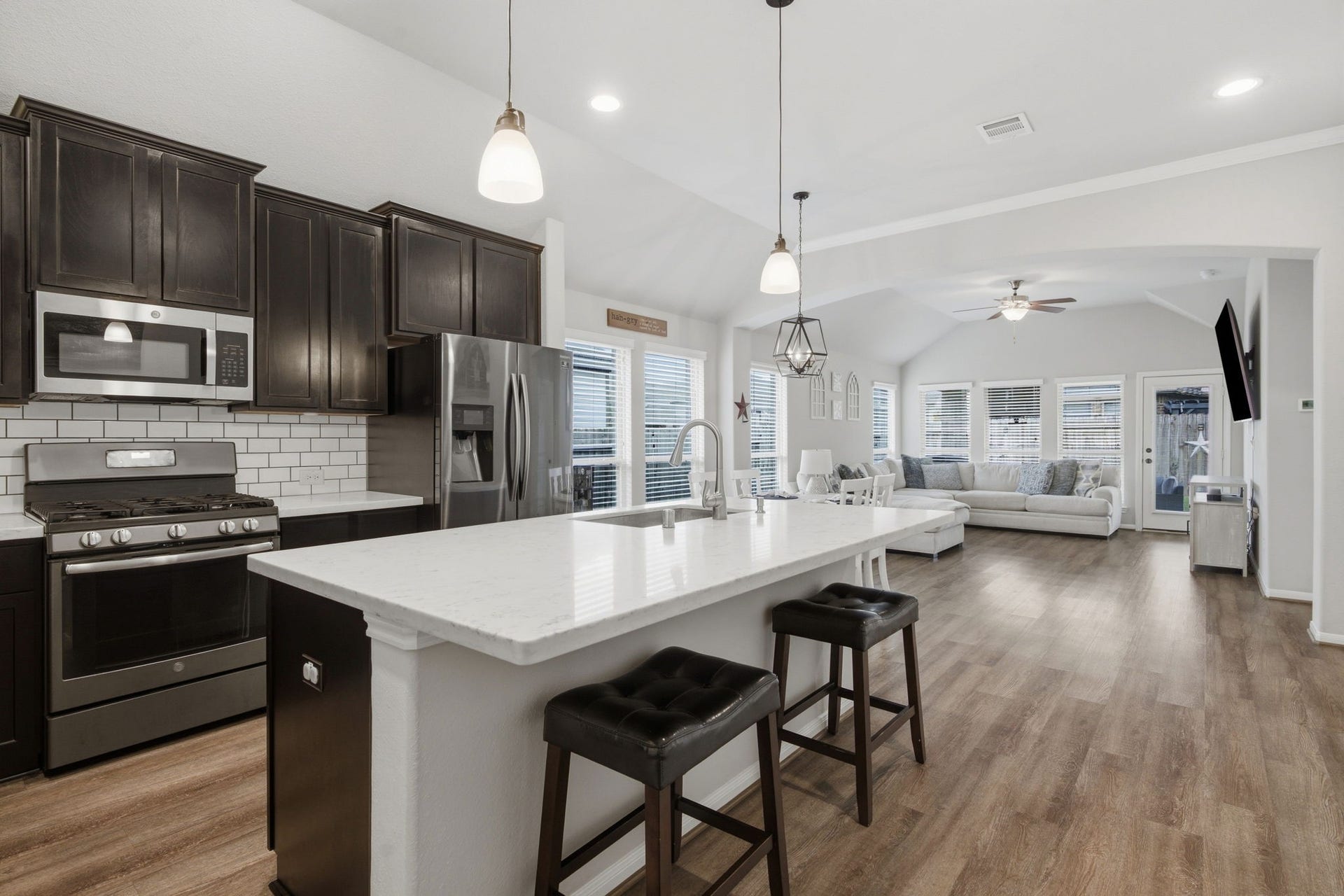 17410 Farm Pasture Trail, Hockley, TX 77447 Kitchen is equipped with large island, upgraded quartz, upgraded subway tile, pendant lights and deep stainless sink.