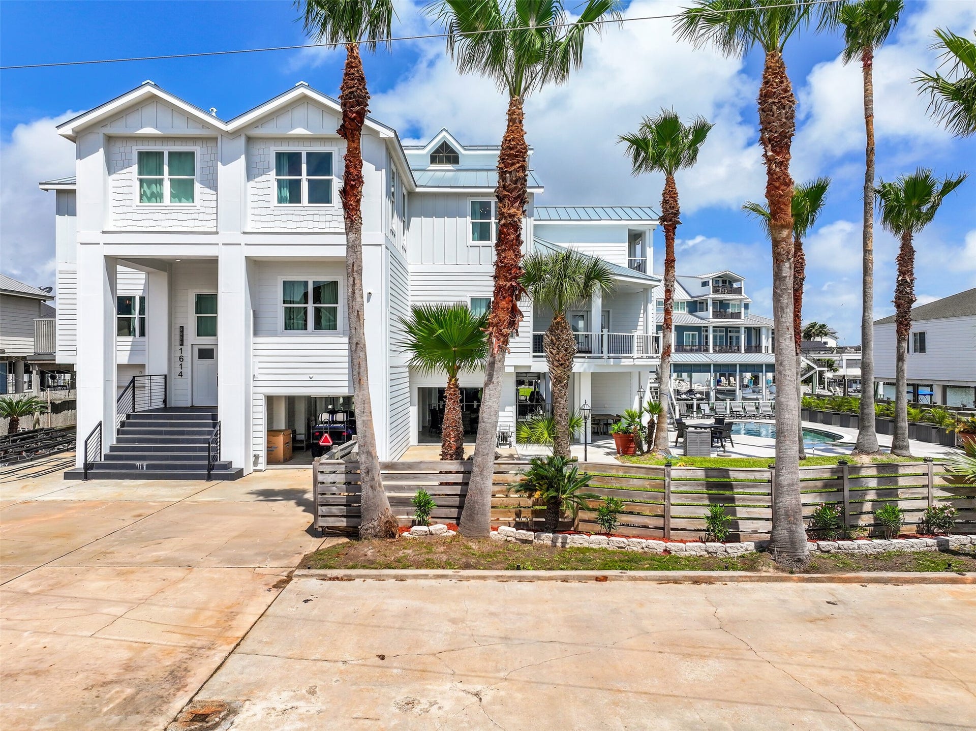 1614 Castaway Street, Tiki Island, TX 77554 THIS is Tiki Island living on a different scale. Two waterfront lots with 132 feet of canal frontage create an incredible setting for boating, entertaining and making life on the water an everyday experience.