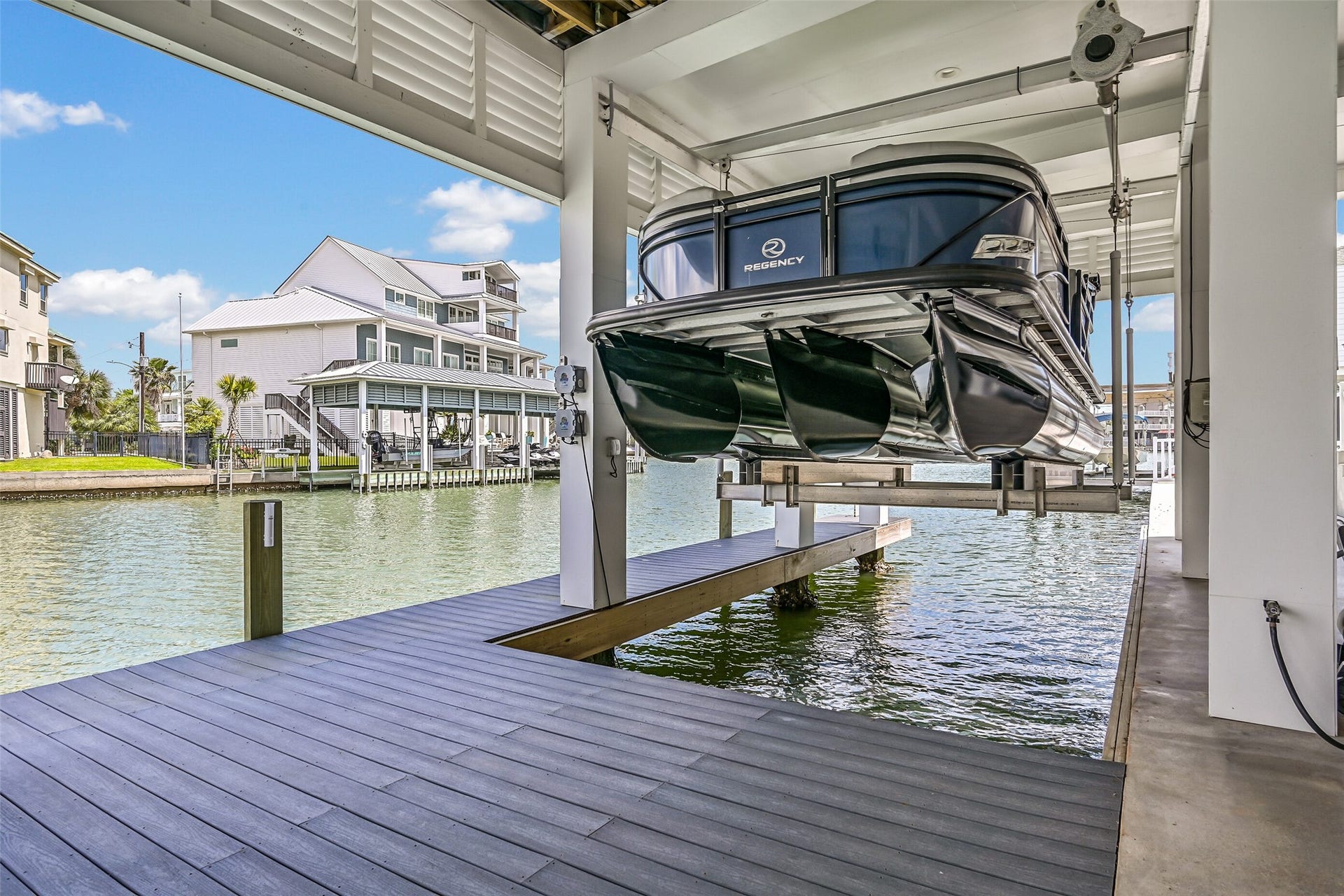 1614 Castaway Street, Tiki Island, TX 77554 Your next day on the water can begin at home. The boathouse, lifts and deep-water canal access make spontaneous boating part of the appeal of owning on Tiki.