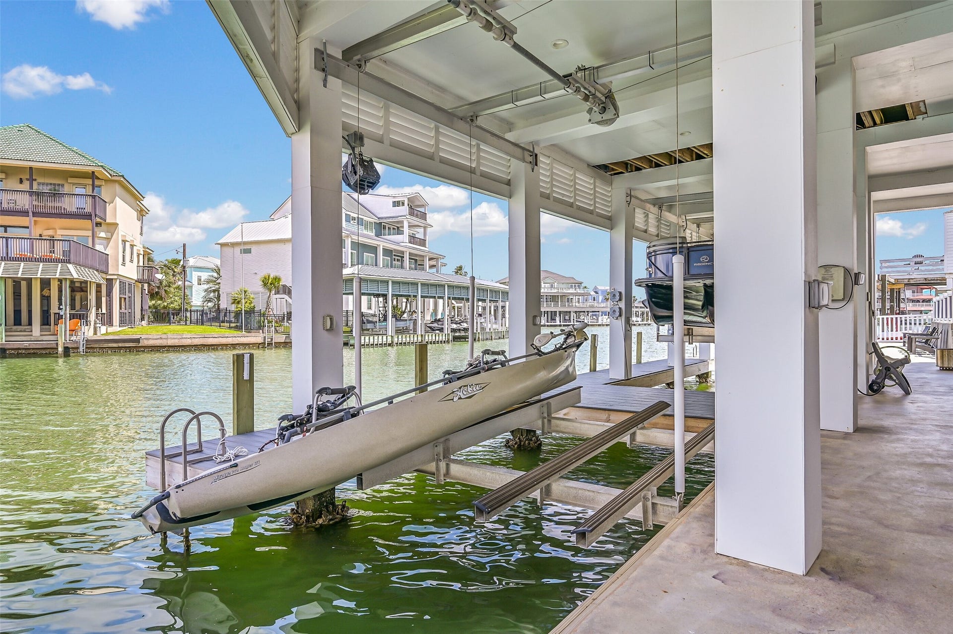 1614 Castaway Street, Tiki Island, TX 77554 The best Tiki mornings can start right here. Walk downstairs, step onto the dock and head out on the water with covered lift access just beyond your door.
