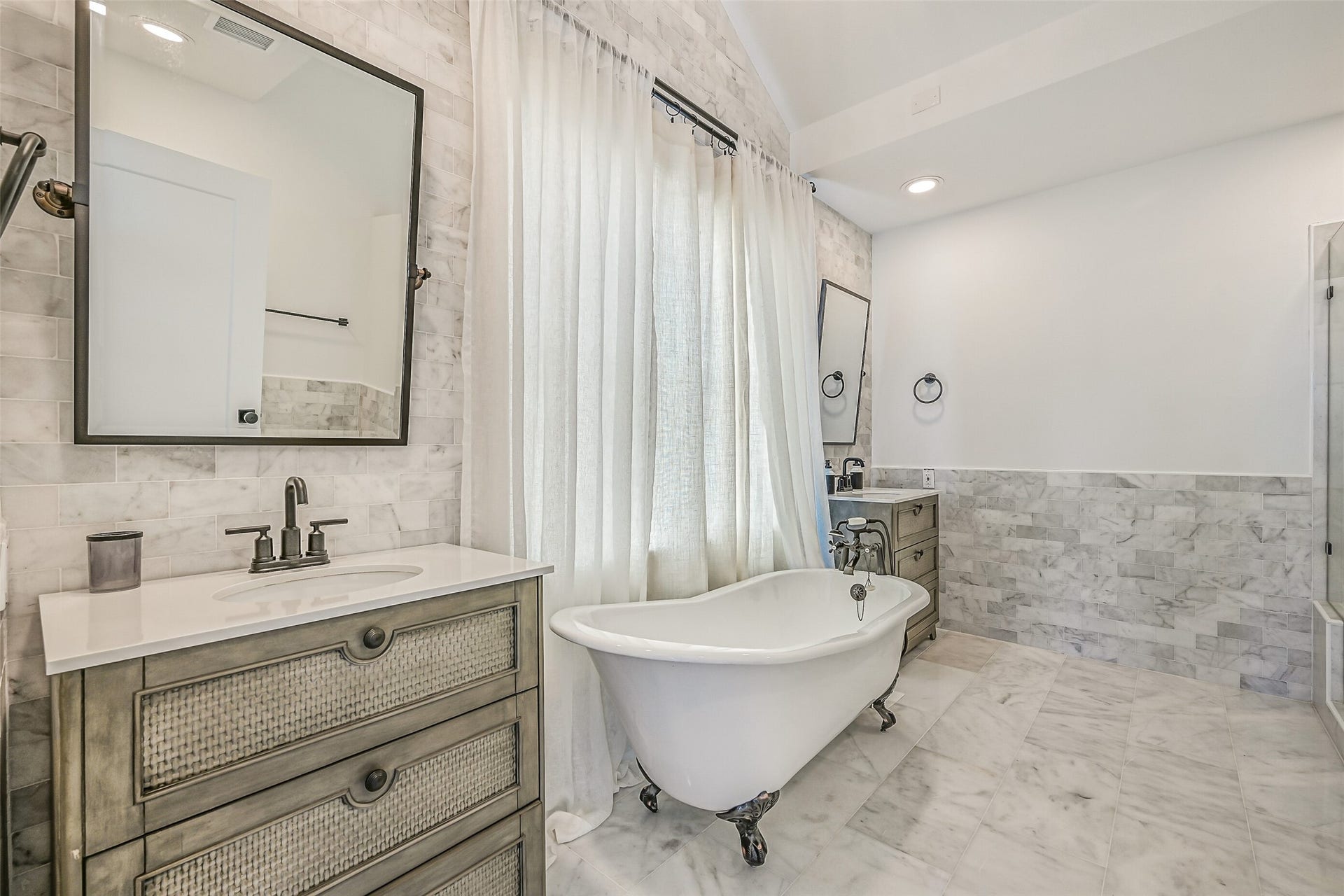 1614 Castaway Street, Tiki Island, TX 77554 A freestanding clawfoot tub gives this ensuite plenty of personality. Guests have their own comfortable space to unwind at the end of the day.