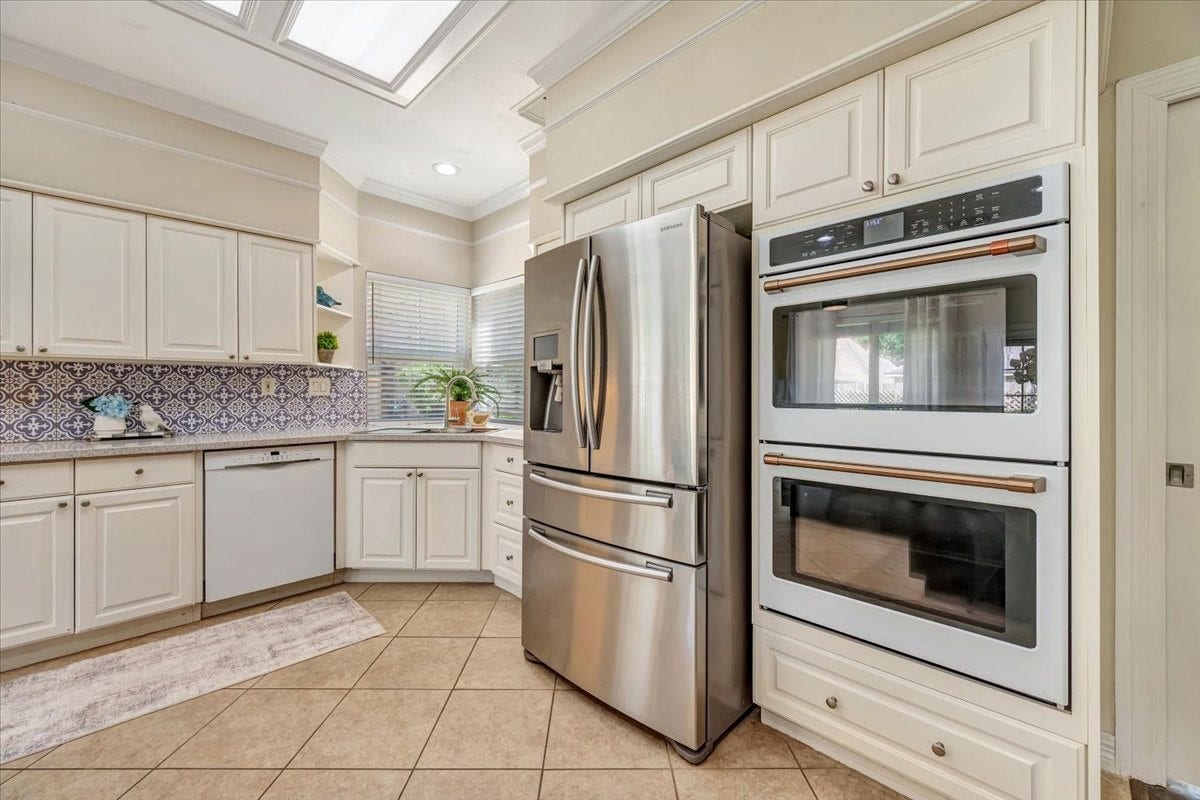 Recent double ovens, updtaed sink and refrigerator stays with the home.