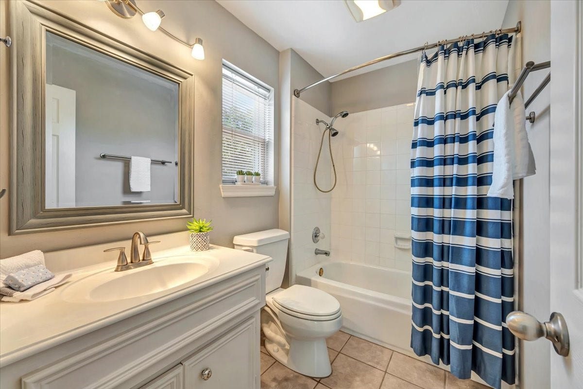 This bathroom is attached as a private bath to a secondary bedroom.