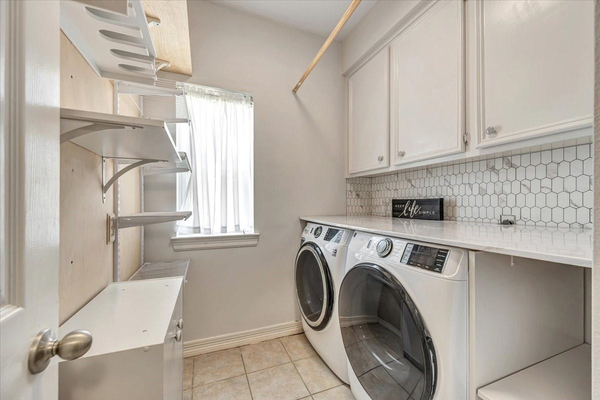 Laundry room with storage and washer and dryer will remain with the home.
