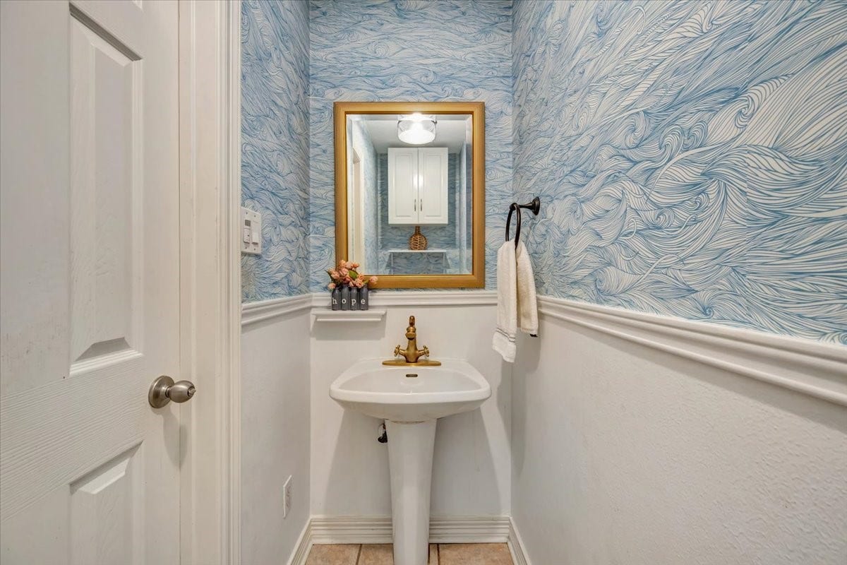 Powder bath is in a great location on short hallway by the laundry room.