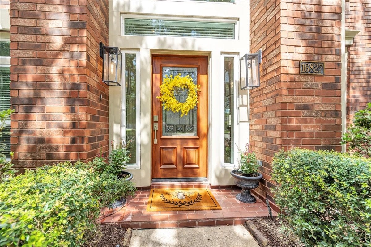 Inviting front entry accented by a beautiful recent wood and glass door, sidelights and an abundance of natural light that open into a grand entry.
