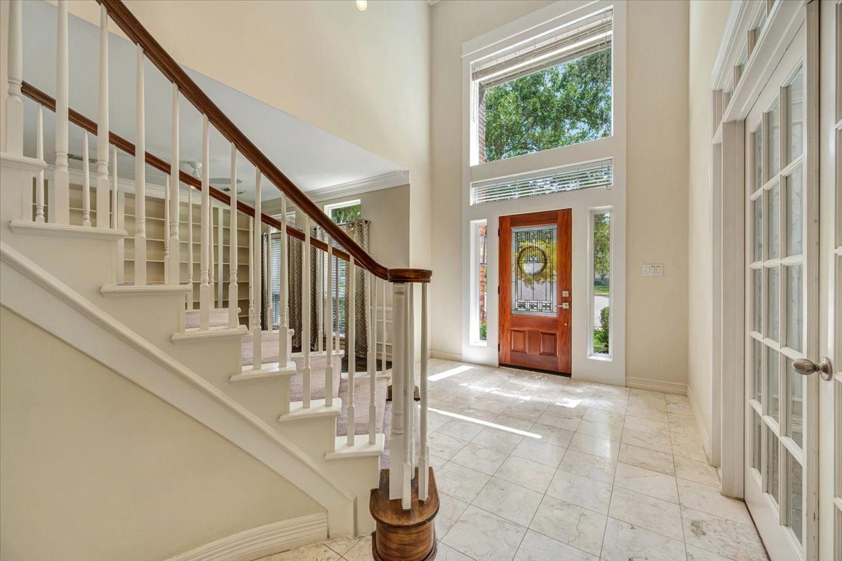A dramatic two-story entry welcomes you with abundant natural light, tile flooring and a graceful curved staircase.