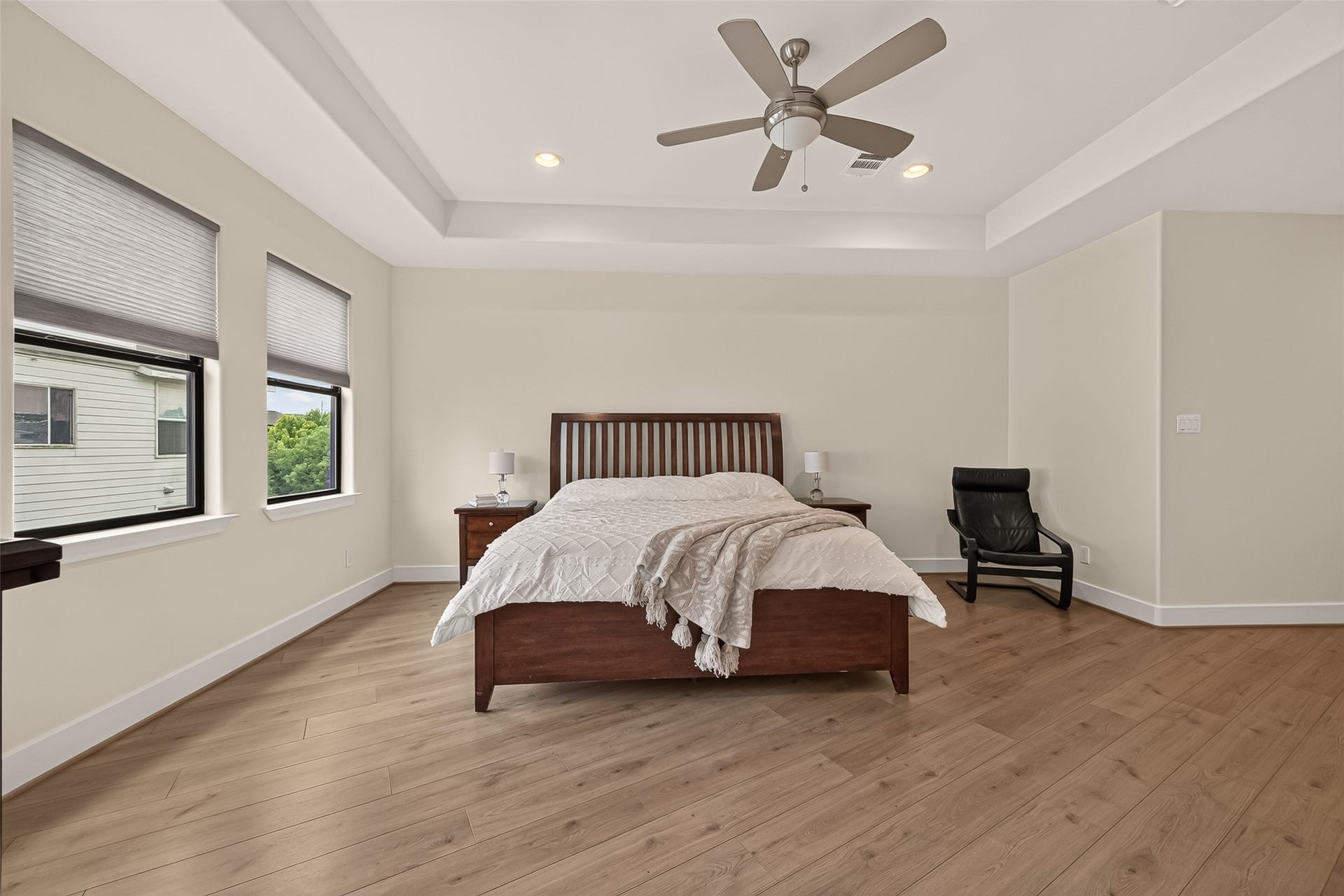 Another view of the bright and airy primary bedroom.
