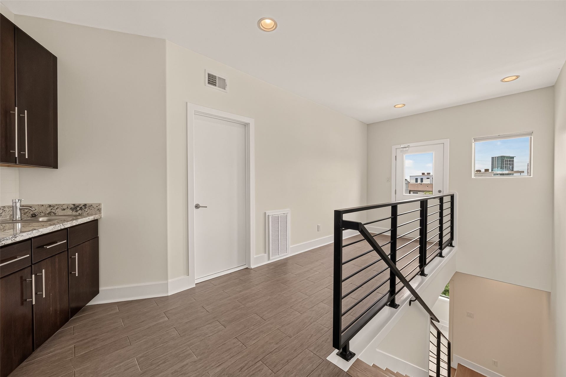 Landing to the two rooftop decks with a wet bar for convenient rooftop entertaining.