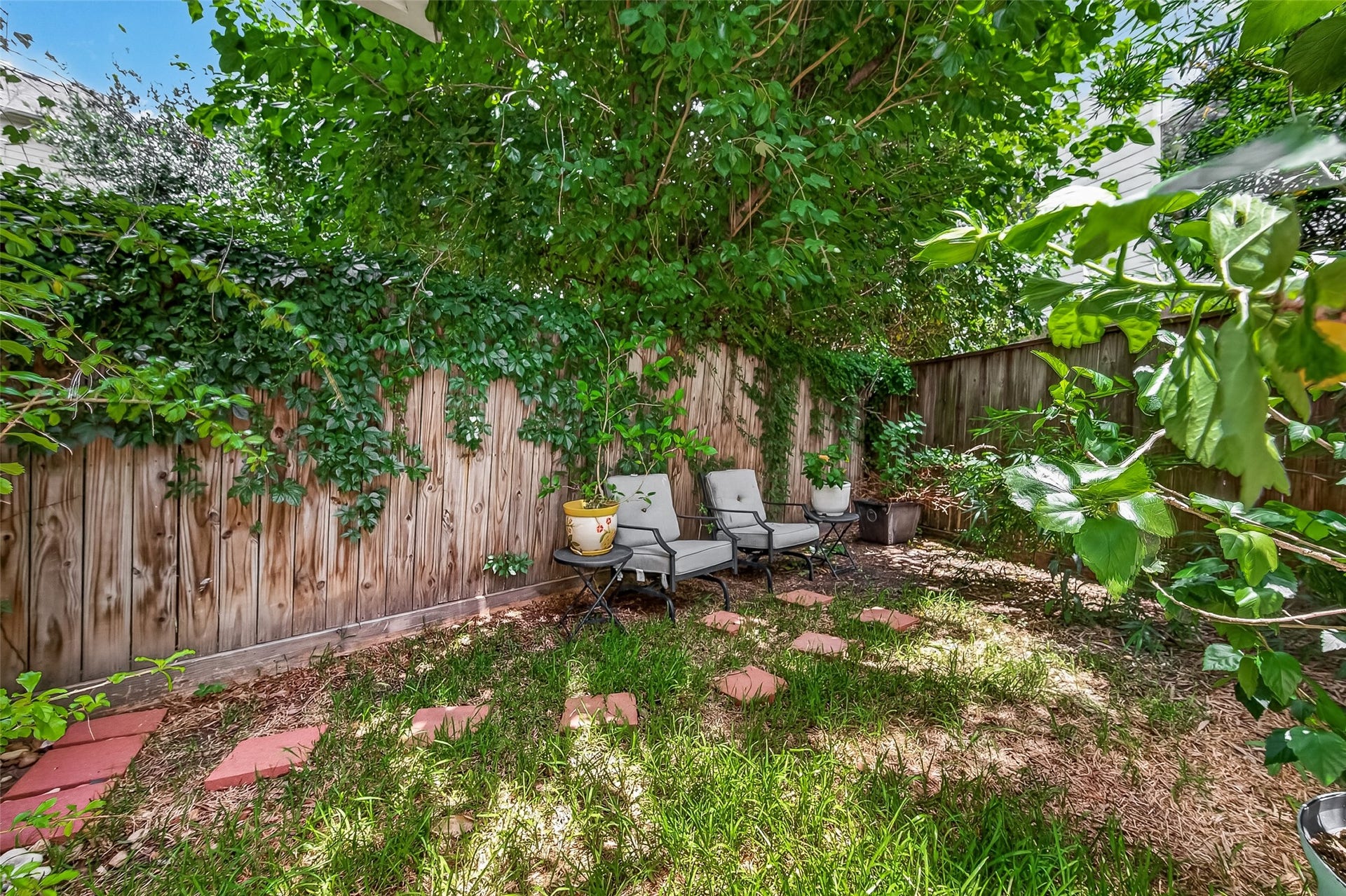 This cozy fenced backyard has room for seating providing yet another outdoor space for relaxation and outdoor enjoyment.