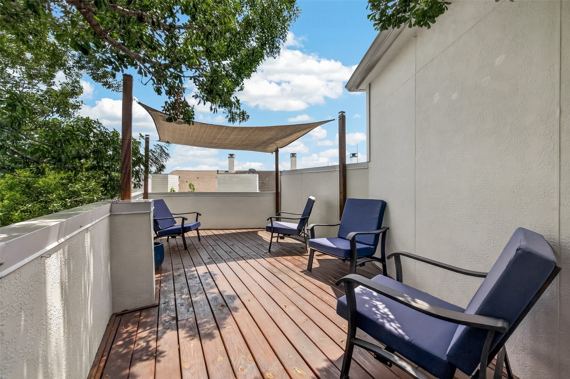 The second rooftop deck is shaded by a sail canopy.