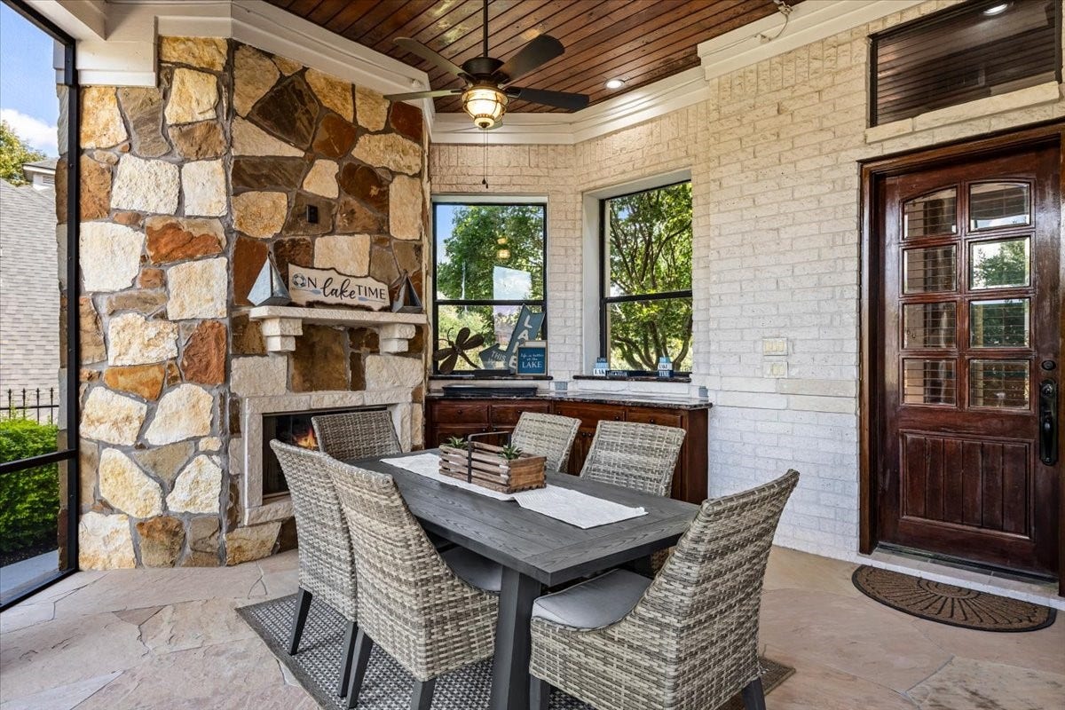 11860 Grand Harbor Boulevard, Montgomery, TX 77356 Downstairs screen patio seating area with fireplace and gas range. Located just off the kitchen for easy outdoor dining!