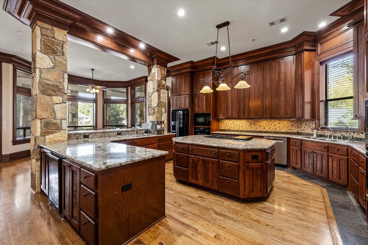 11860 Grand Harbor Boulevard, Montgomery, TX 77356 Custom finishes at every angle. From the stone columns to the cabinetry to the double sinks, double ovens and double microwaves. No detail was left out.