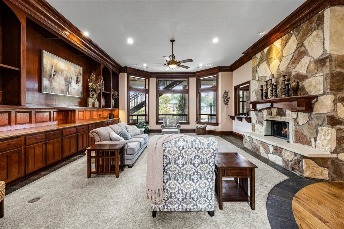 11860 Grand Harbor Boulevard, Montgomery, TX 77356 Floor to ceiling cabinetry on one side accompanied by the focal point of the room--the double side stone fireplace. The living room offers a spacious layout with many entraining options.