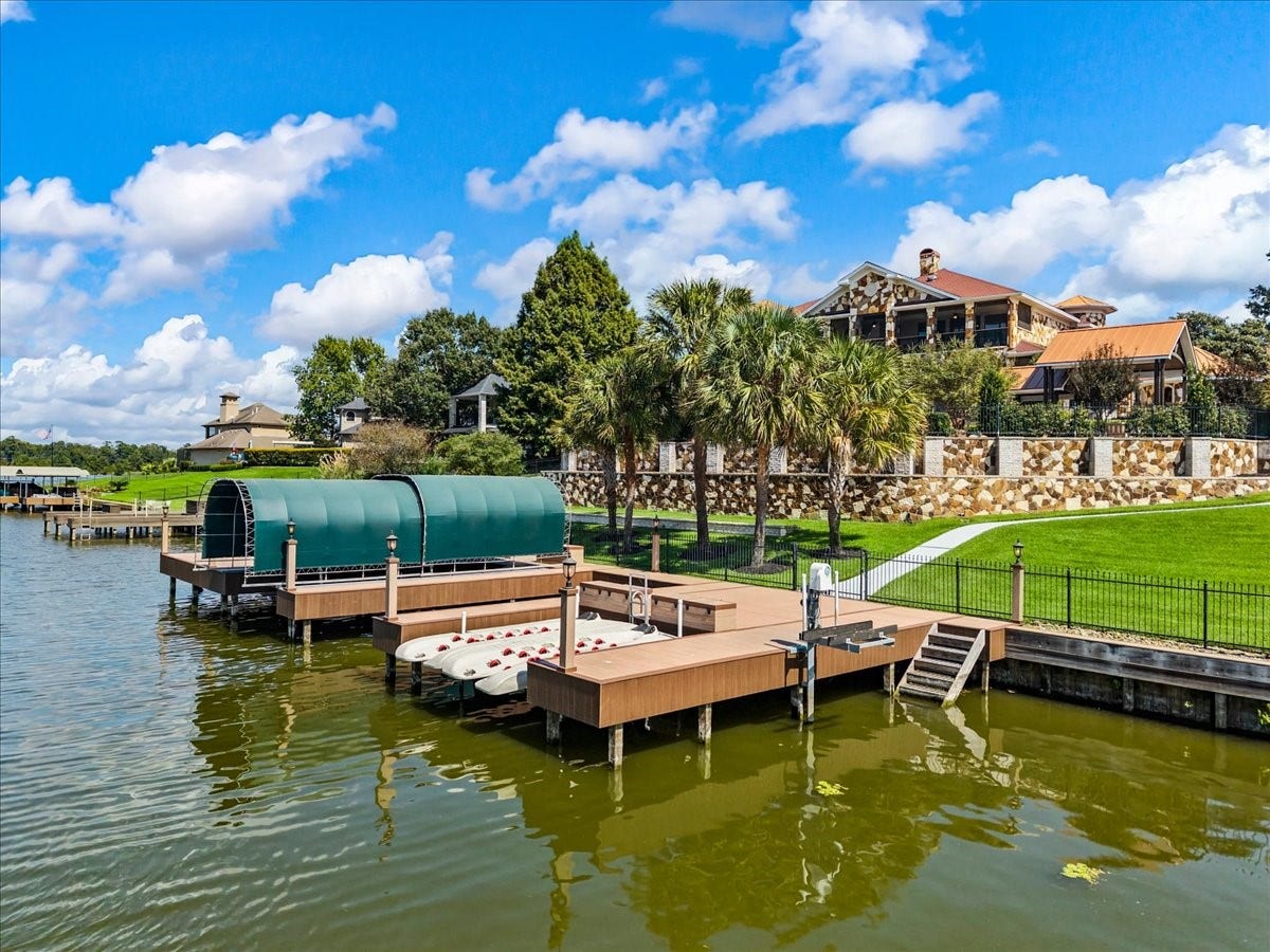 11860 Grand Harbor Boulevard, Montgomery, TX 77356 Recently replaced composite decking, 3 optional slips, 1 covered with lifts, 3 jetski lifts and stairs into water. Over 100 ft of waterfrontage on Lake Conroe.