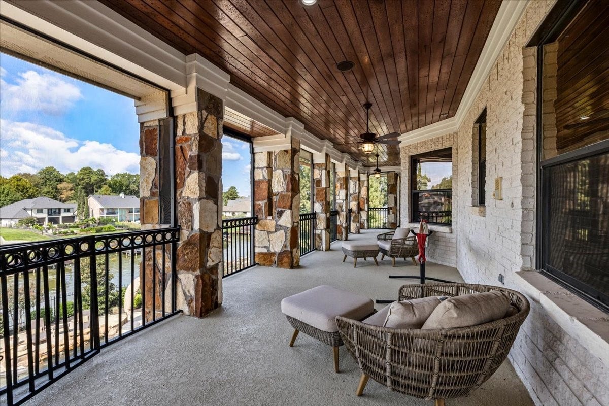 11860 Grand Harbor Boulevard, Montgomery, TX 77356 Upstairs balcony extends the full length of the back of the home. Many different seating areas and a staircase to downstairs patio as well.
