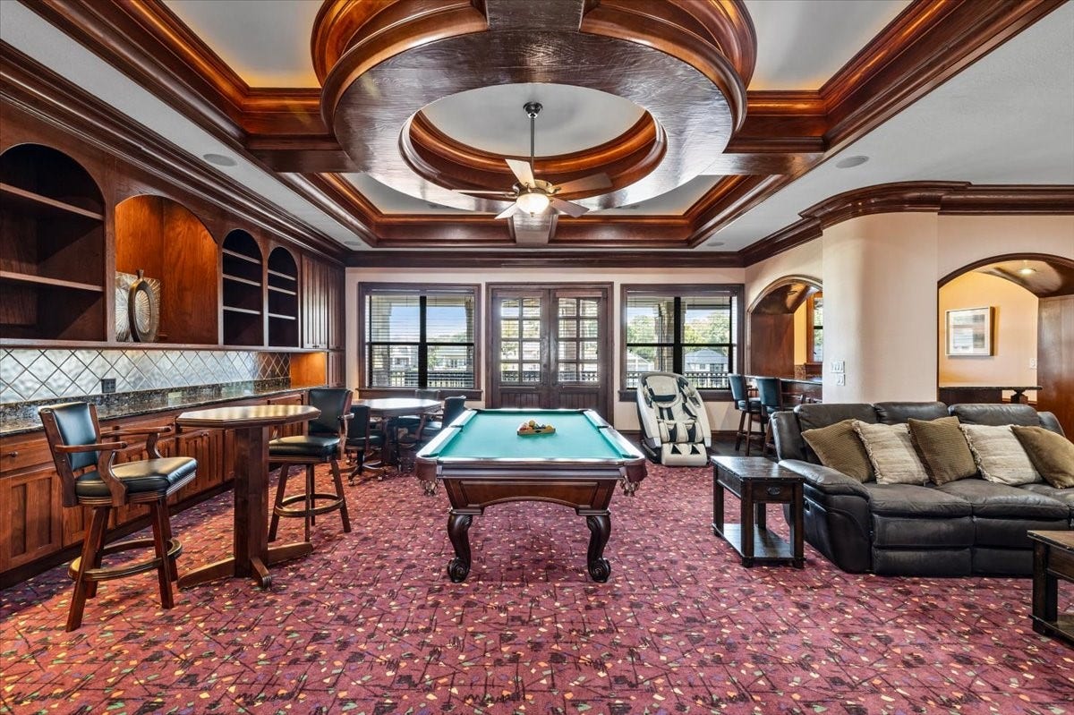 11860 Grand Harbor Boulevard, Montgomery, TX 77356 Indoor fun starts here! Billiards, poker, darts, wetbar, bar tops, TV area! On top of the double doors to access the upstairs screened-in patio!