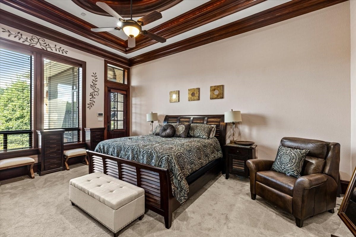 11860 Grand Harbor Boulevard, Montgomery, TX 77356 Primary bedroom with detailed raising ceilings, each level paired with millwork to showcase it. Door access to the back patio or easy access to the second gazebo.