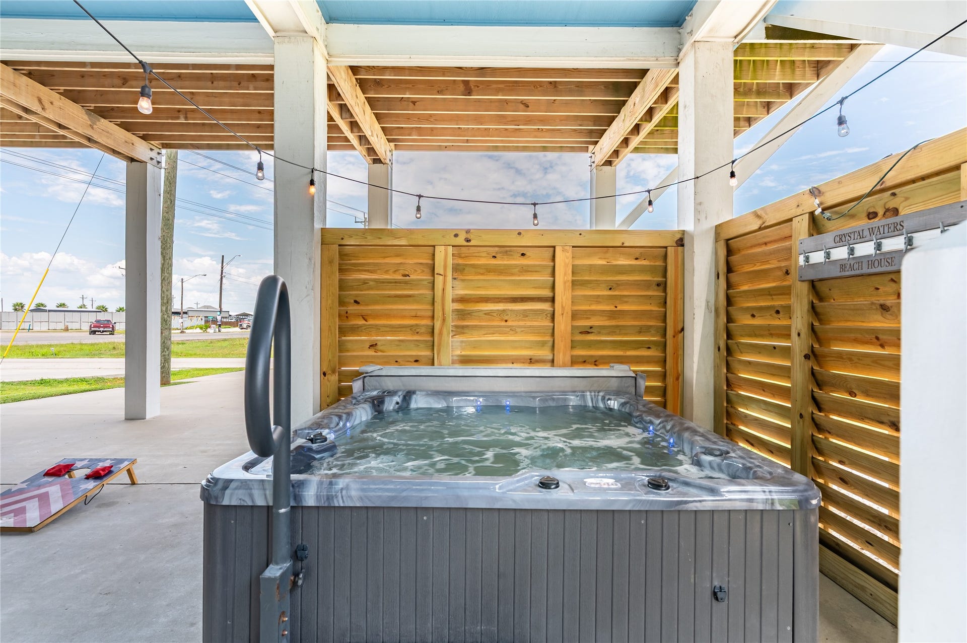 997 S Redfish Street, Crystal Beach, TX 77650 Melt into your private hot tub after a day at the beach, surrounded by privacy screening and twinkling string lights.