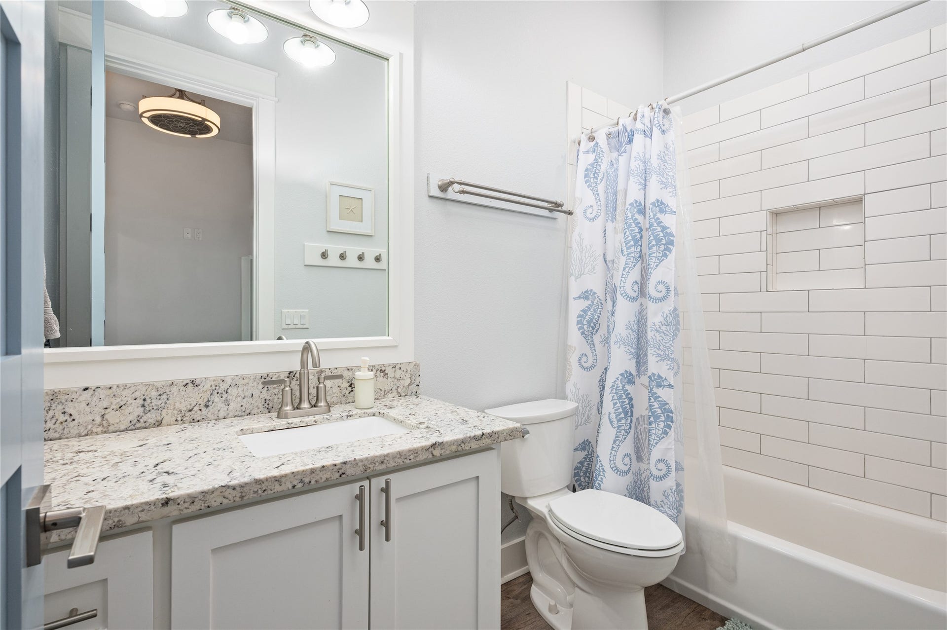 997 S Redfish Street, Crystal Beach, TX 77650 Your full bath pairs a granite-topped vanity with a subway-tile tub and shower surround for a clean, timeless finish.
