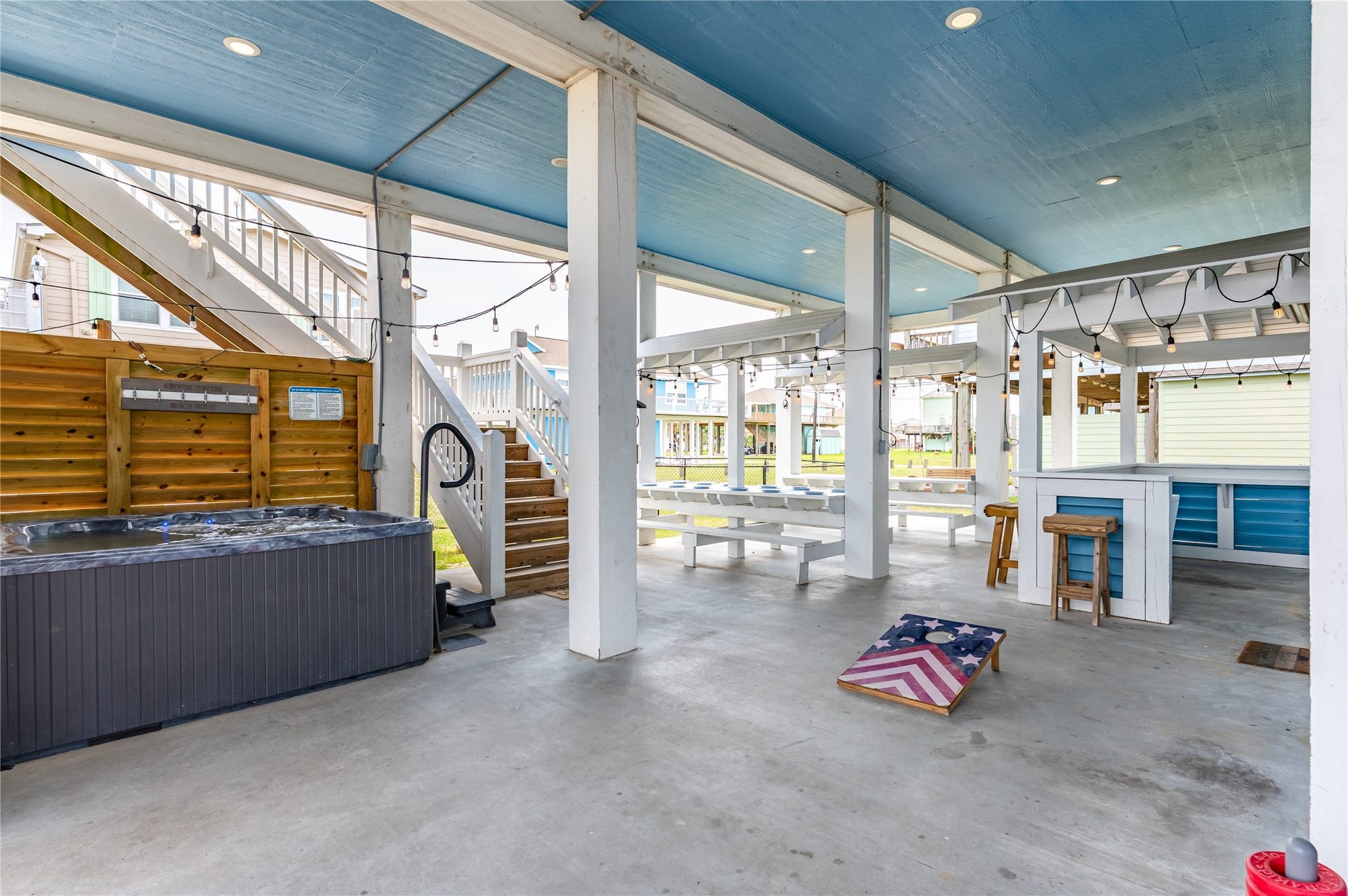 997 S Redfish Street, Crystal Beach, TX 77650 Downstairs is built for fun, with your hot tub, game space, bar seating, and plenty of covered room for everyone to hang out.