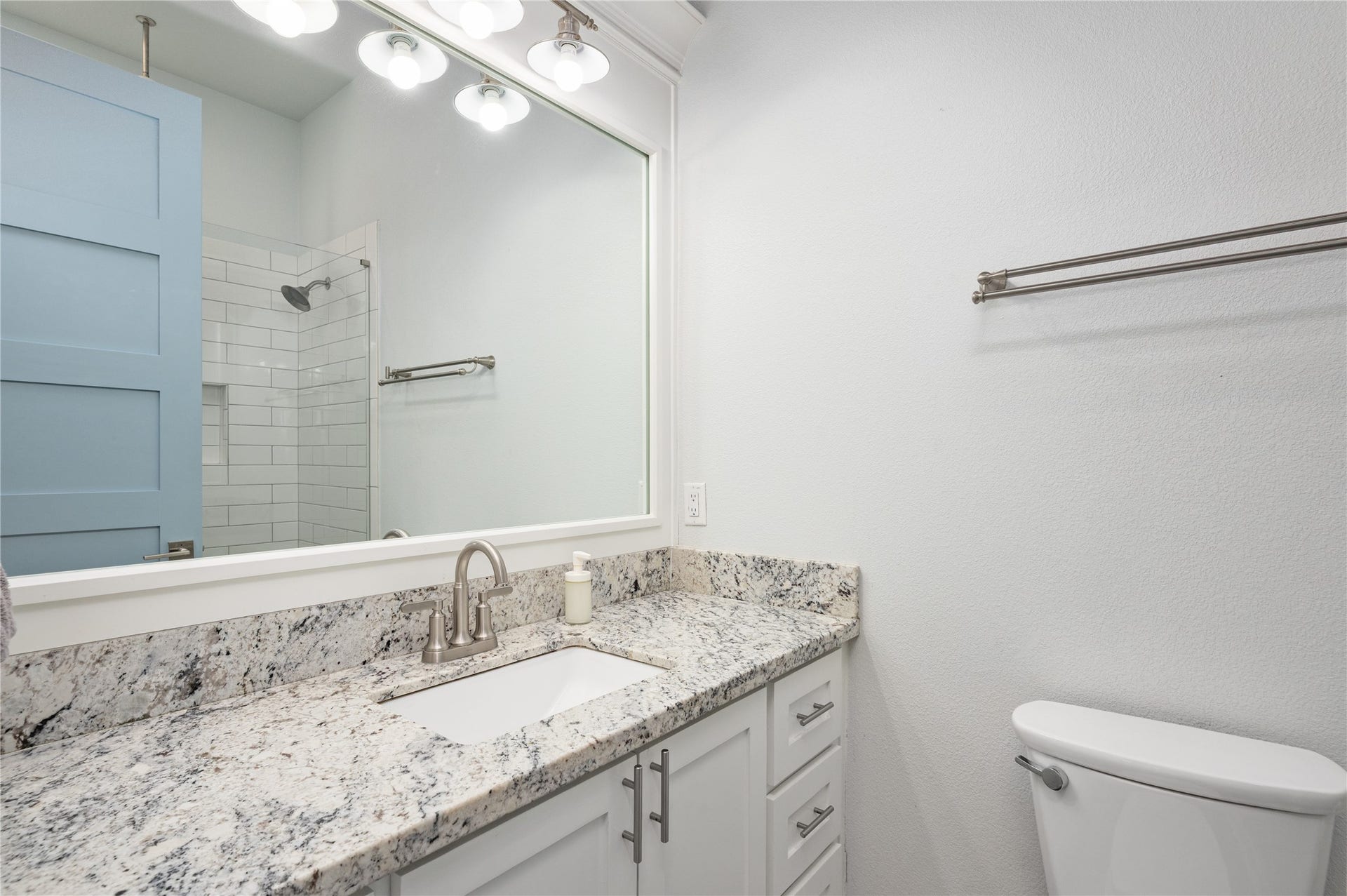 997 S Redfish Street, Crystal Beach, TX 77650 Getting ready is easy in your bright bathroom, featuring a granite-topped vanity, generous mirror, and coordinating subway-tile shower.