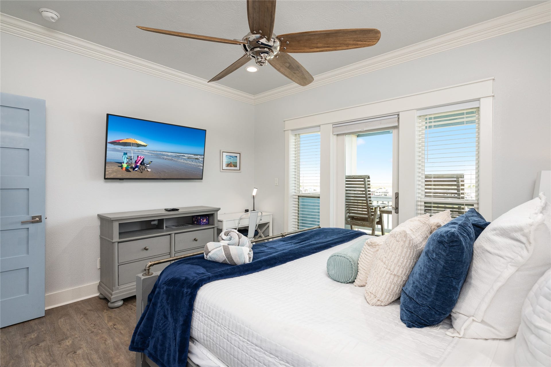 997 S Redfish Street, Crystal Beach, TX 77650 Wake up to natural light in this inviting bedroom, then step directly onto the covered balcony for a quiet start to the day.