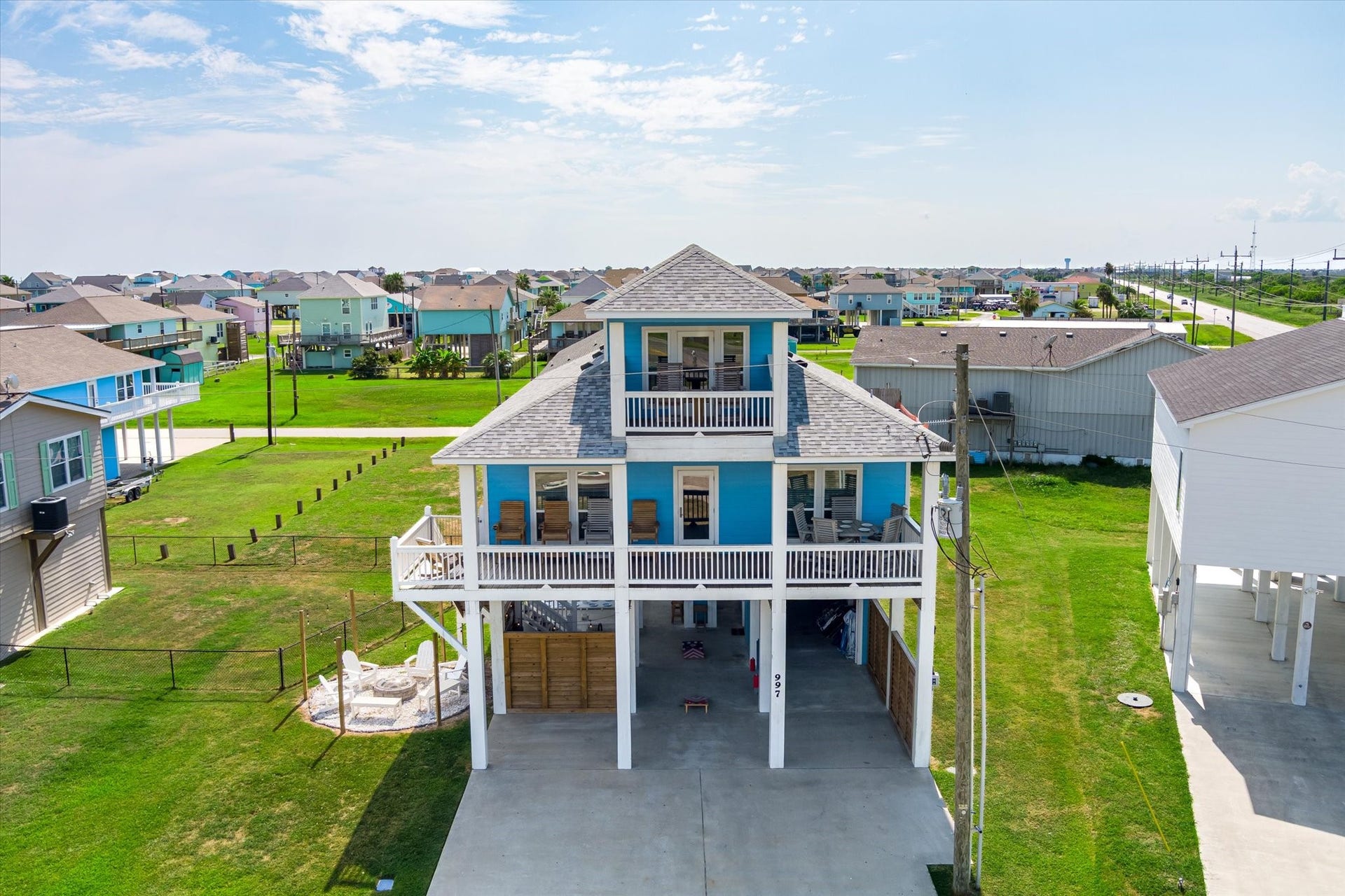 997 S Redfish Street, Crystal Beach, TX 77650 Theres no mistaking your beach house with its cheerful blue exterior, expansive covered balcony, and elevated coastal design.