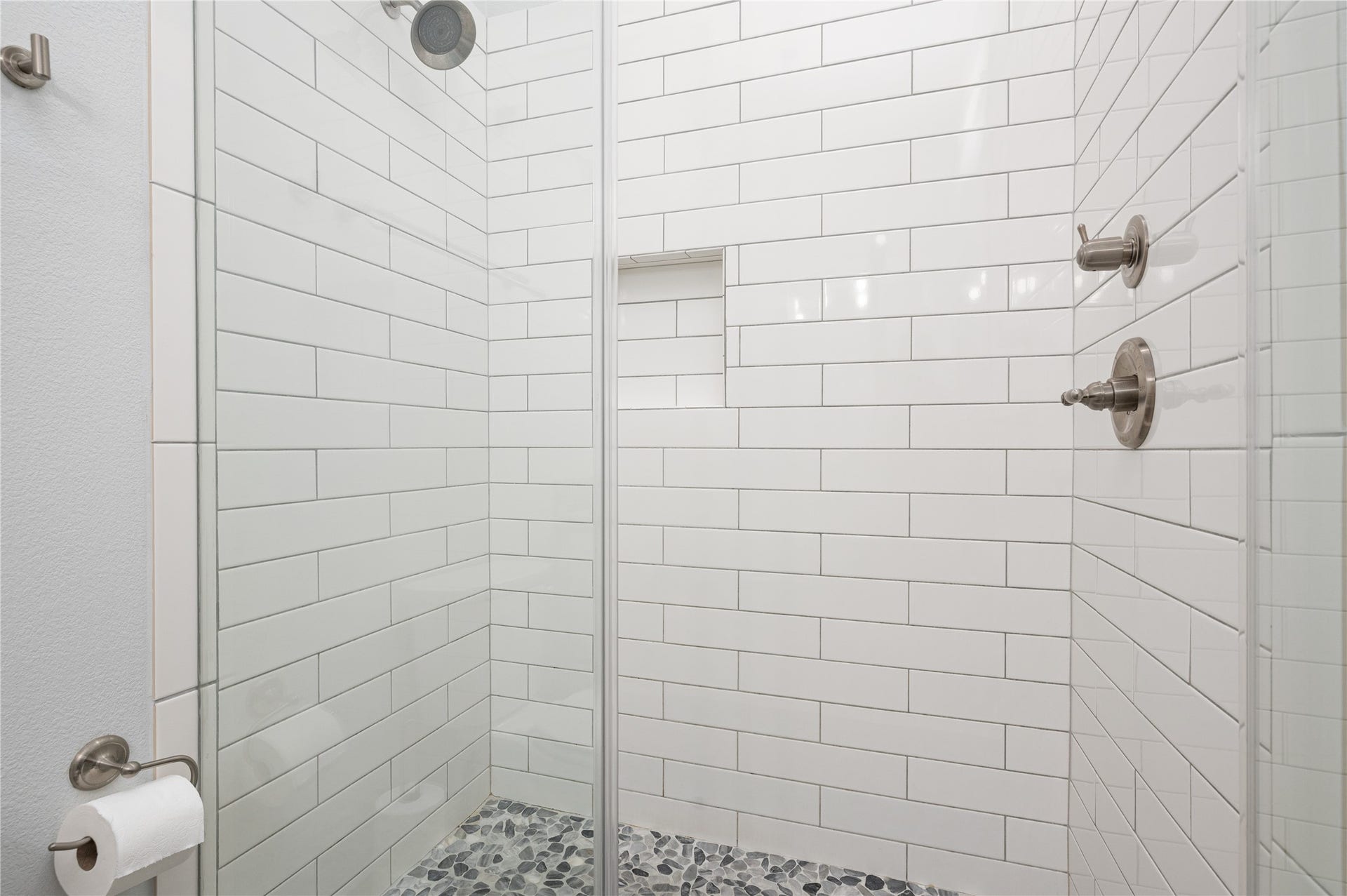 997 S Redfish Street, Crystal Beach, TX 77650 Start each day in your sleek walk-in shower, finished with crisp subway tile, a pebble-style floor, and a convenient built-in niche.