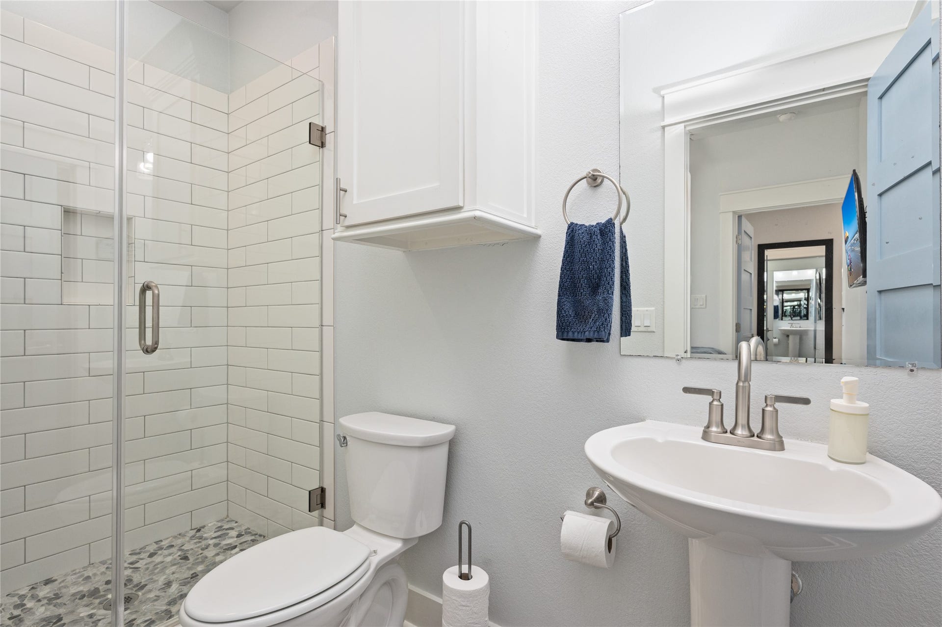 997 S Redfish Street, Crystal Beach, TX 77650 Start and end your day in a private bath with a glass-enclosed tiled shower and convenient built-in storage.