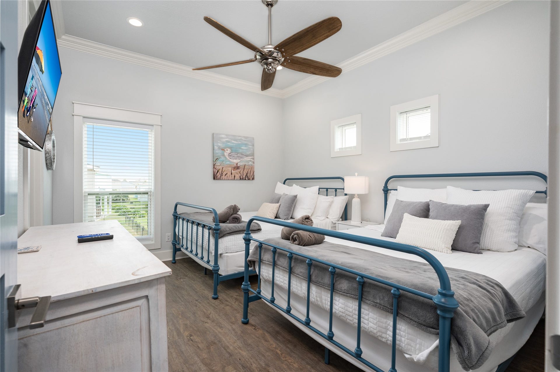 997 S Redfish Street, Crystal Beach, TX 77650 Guests have a comfortable place of their own in this bright bedroom, complete with two beds, a ceiling fan, and plenty of natural light.