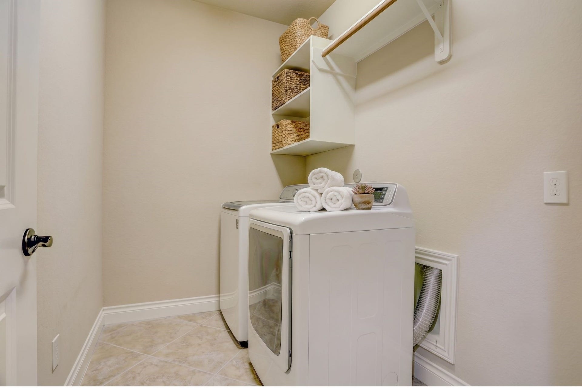 13308 Paxton Hill Court, Pearland, TX 77584 Spacious utility room with built-in shelving, ample storage, and enough room to accommodate a second refrigerator or freezer, adding everyday convenience and extra storage for busy households.