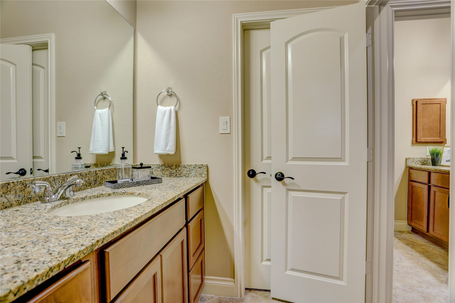 13308 Paxton Hill Court, Pearland, TX 77584 Convenient Jack-and-Jill bathroom featuring a granite vanity, generous counter space, and a functional layout that provides privacy while seamlessly connecting two upstairs bedrooms, perfect for family members or overnight guests.