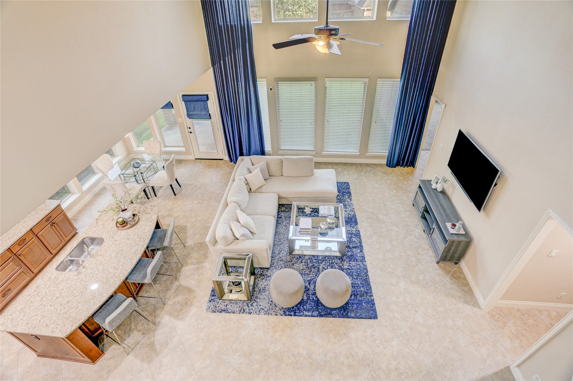 13308 Paxton Hill Court, Pearland, TX 77584 An impressive bird's-eye view showcases the home's dramatic two-story family room, open-concept layout, and seamless flow between the kitchen, breakfast area, and living space. Soaring ceilings and expansive windows fill the home with natural light, creating an inviting atmosphere for everyday living and entertaining.