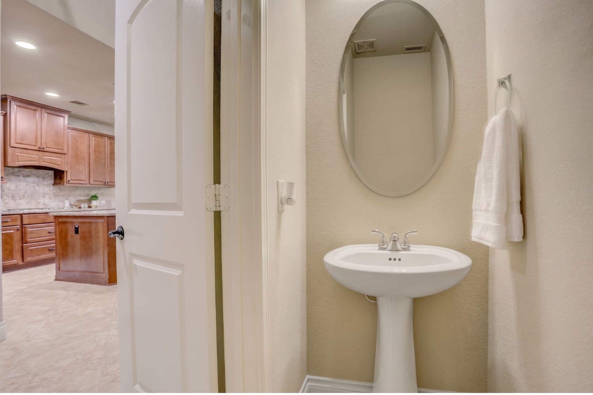 13308 Paxton Hill Court, Pearland, TX 77584 The main level powder bath is ideally situated for entertaining, allowing guests easy access without entering the home's private living spaces.