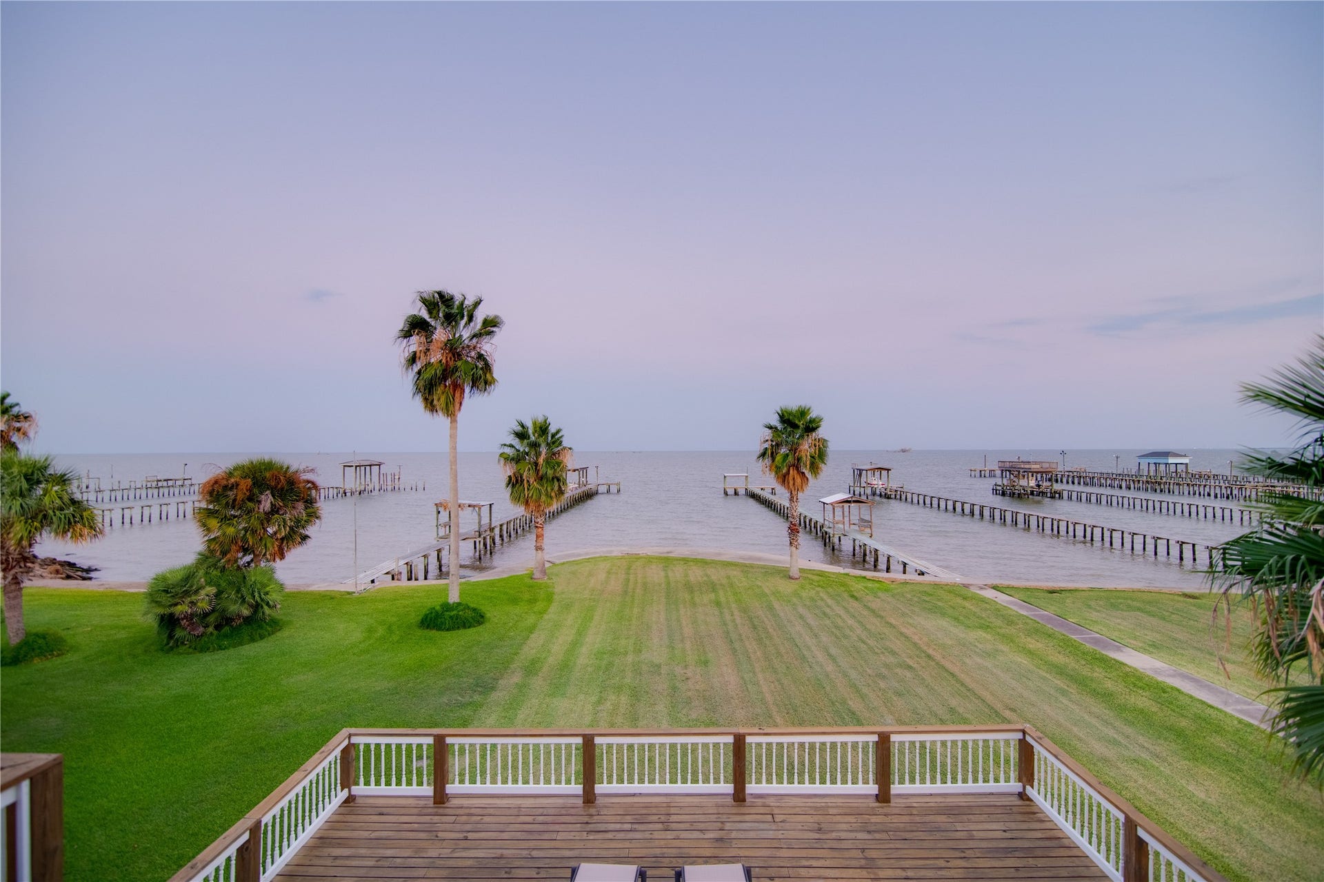 1309 8th Street, San Leon, TX 77539 This large yard opens up to a stunning view of the bay, bordered by a sturdy concrete bulkhead that ensures both safety and durability along the waters edge.