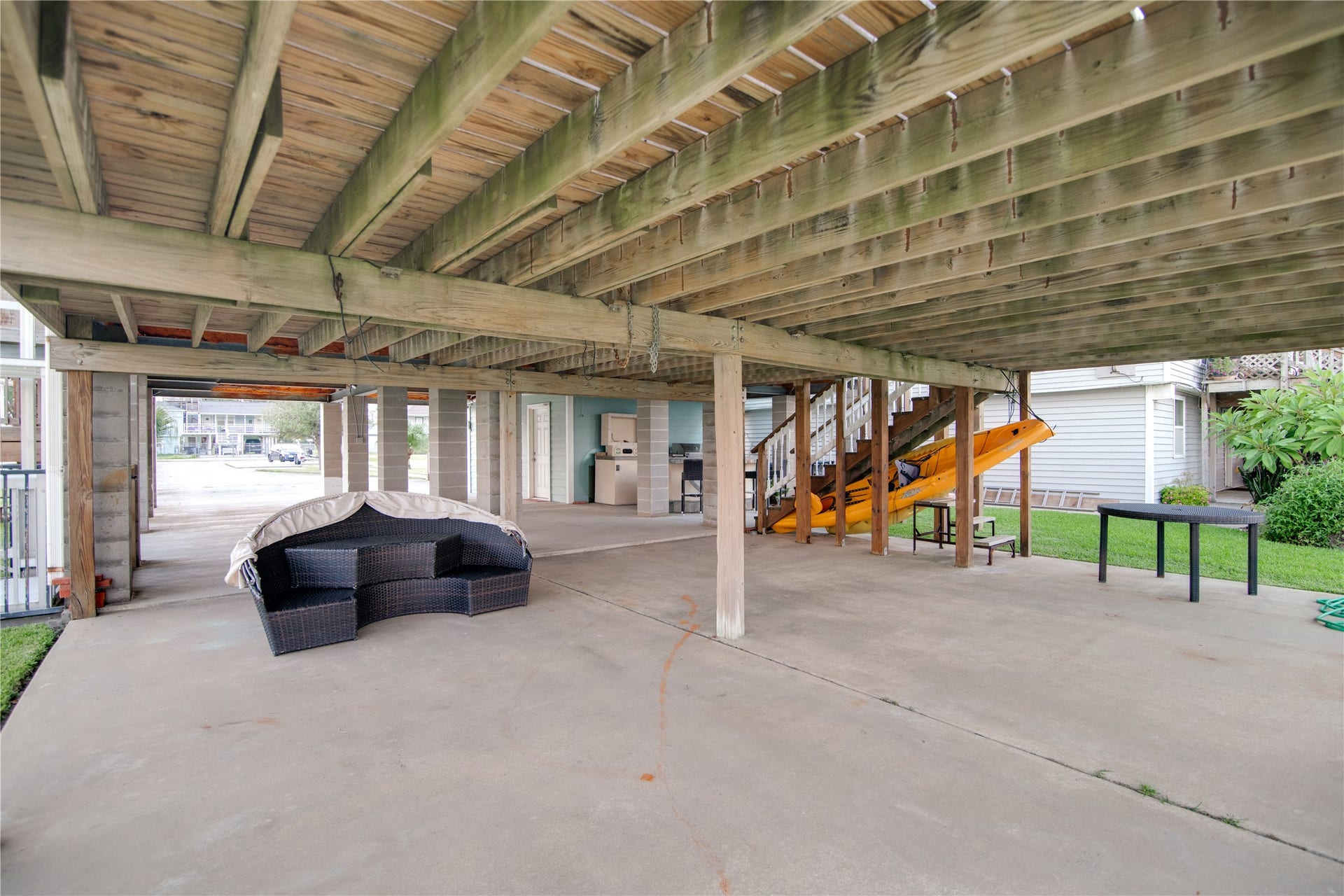 1309 8th Street, San Leon, TX 77539 Beneath this stilted home, a spacious covered area provides the perfect spot for outdoor entertainment and relaxation. The open-air space is sheltered from the elements, making it ideal for dining, gatherings, or simply enjoying the coastal breeze. With plenty of room for seating, parking, or recreational activities, it combines functionality with casual charm, extending the living space while taking full advantage of the waterfront setting.