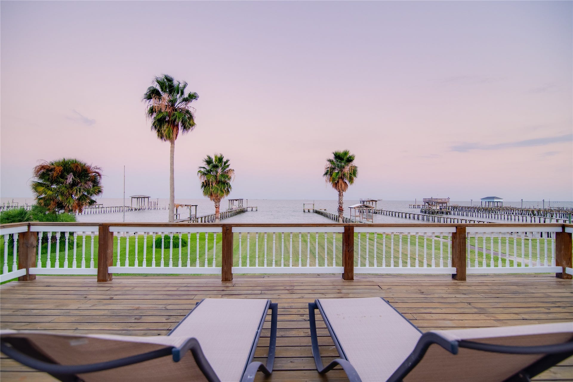 1309 8th Street, San Leon, TX 77539 From the comfort of lounge chairs on the deck, the bay unfolds in a picturesque panorama. Sailboats glide gracefully across the water, cargo ships pass in the distance, and seabirds circle overhead, adding life and movement to the serene scene.