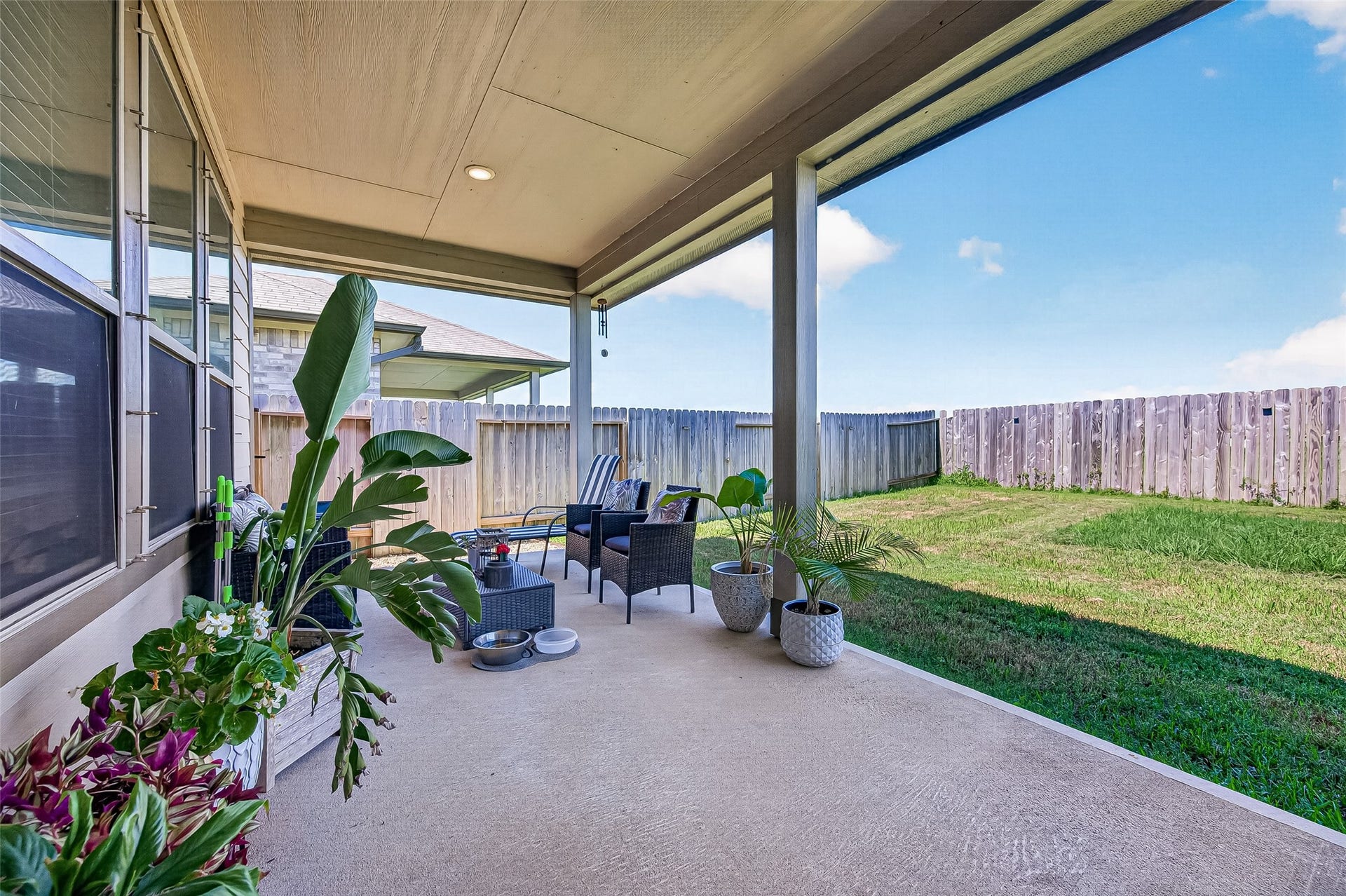8422 Black Pearl Court, Texas City, TX 77591 Spacious covered patio perfect for outdoor relaxation, surrounded by a lush, fenced backyard ideal for privacy and leisure.