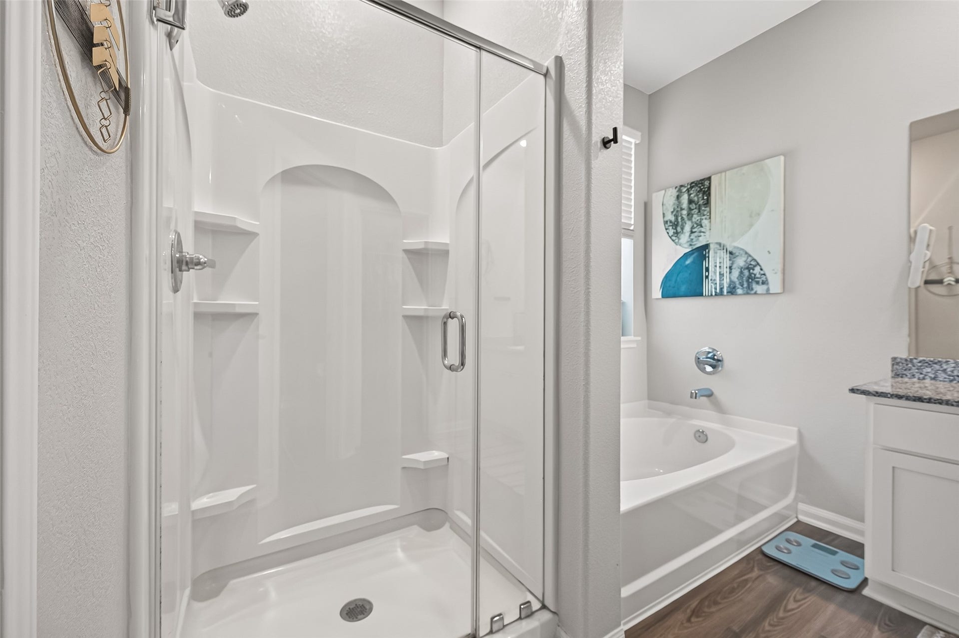 8422 Black Pearl Court, Texas City, TX 77591 Elegant bathroom featuring a spacious walk-in shower with glass doors, a soothing bathtub, and modern fixtures, complemented by stylish decor and granite countertops.