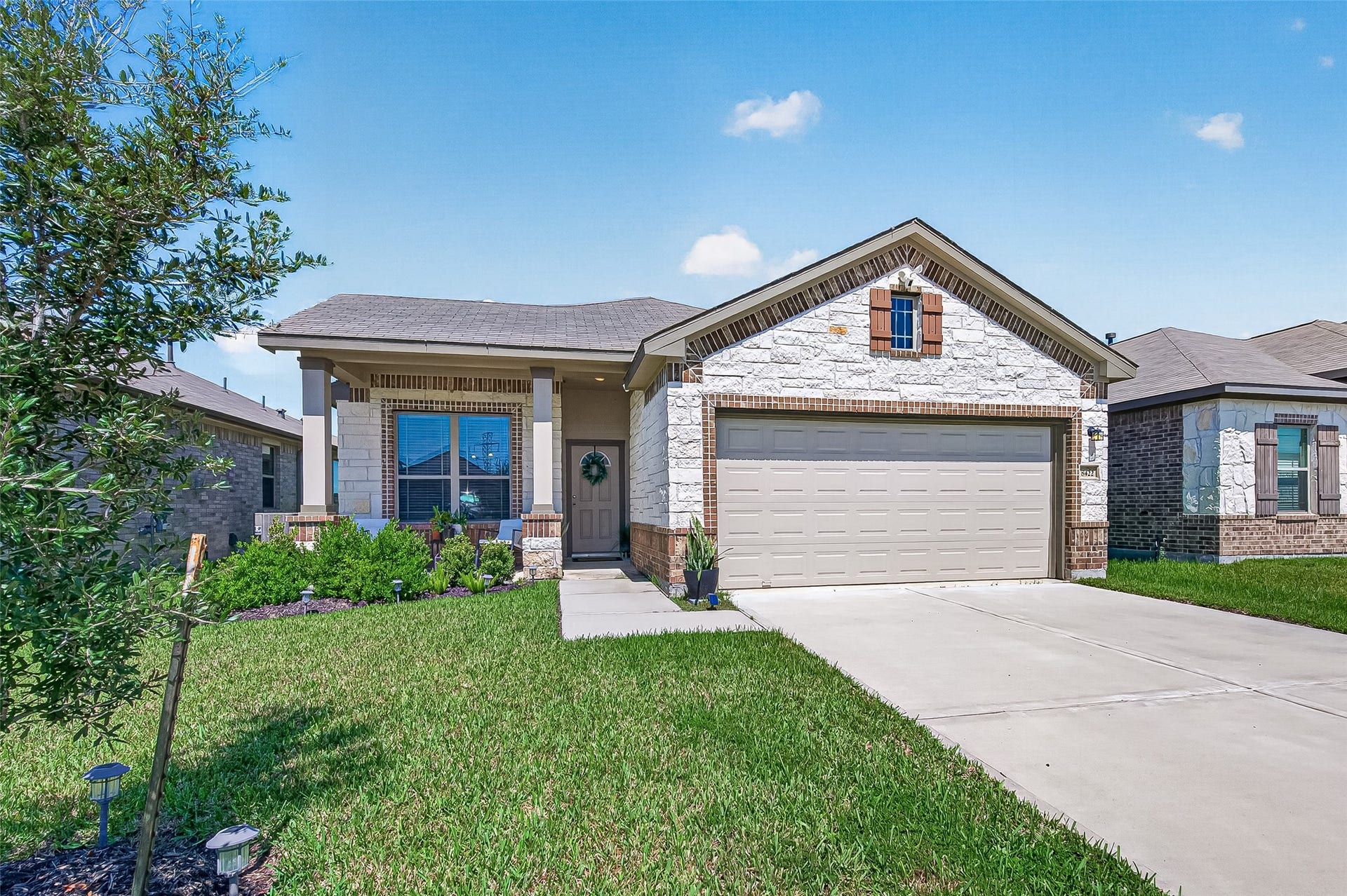 8422 Black Pearl Court, Texas City, TX 77591 Charming single-story home with a welcoming front porch, neatly manicured lawn, and a spacious two-car garage.