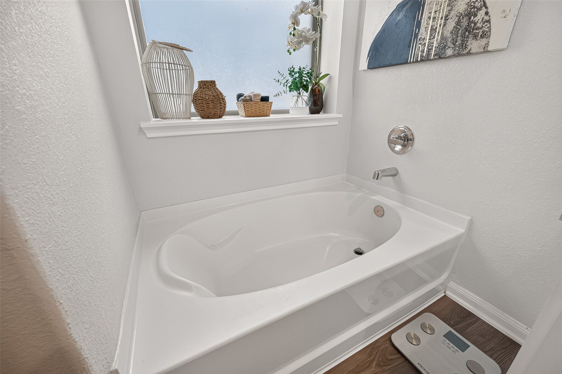 8422 Black Pearl Court, Texas City, TX 77591 Relax in this bright bathroom featuring a sleek soaking tub, a stylish window sill with decorative accents, and modern fixtures.