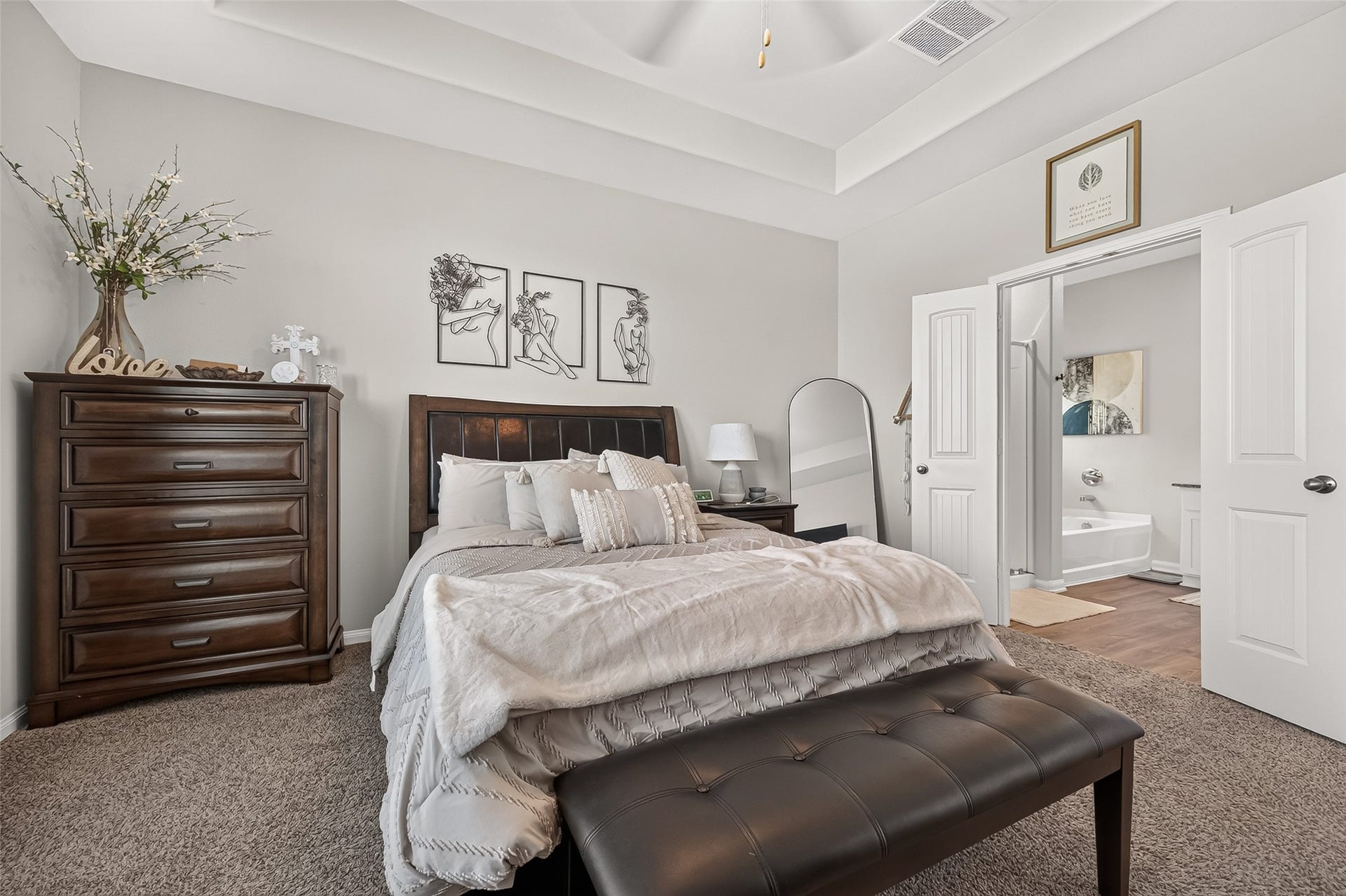 8422 Black Pearl Court, Texas City, TX 77591 Elegant bedroom with a cozy bed, chic decor, and an ensuite bathroom, perfect for relaxation and comfort.