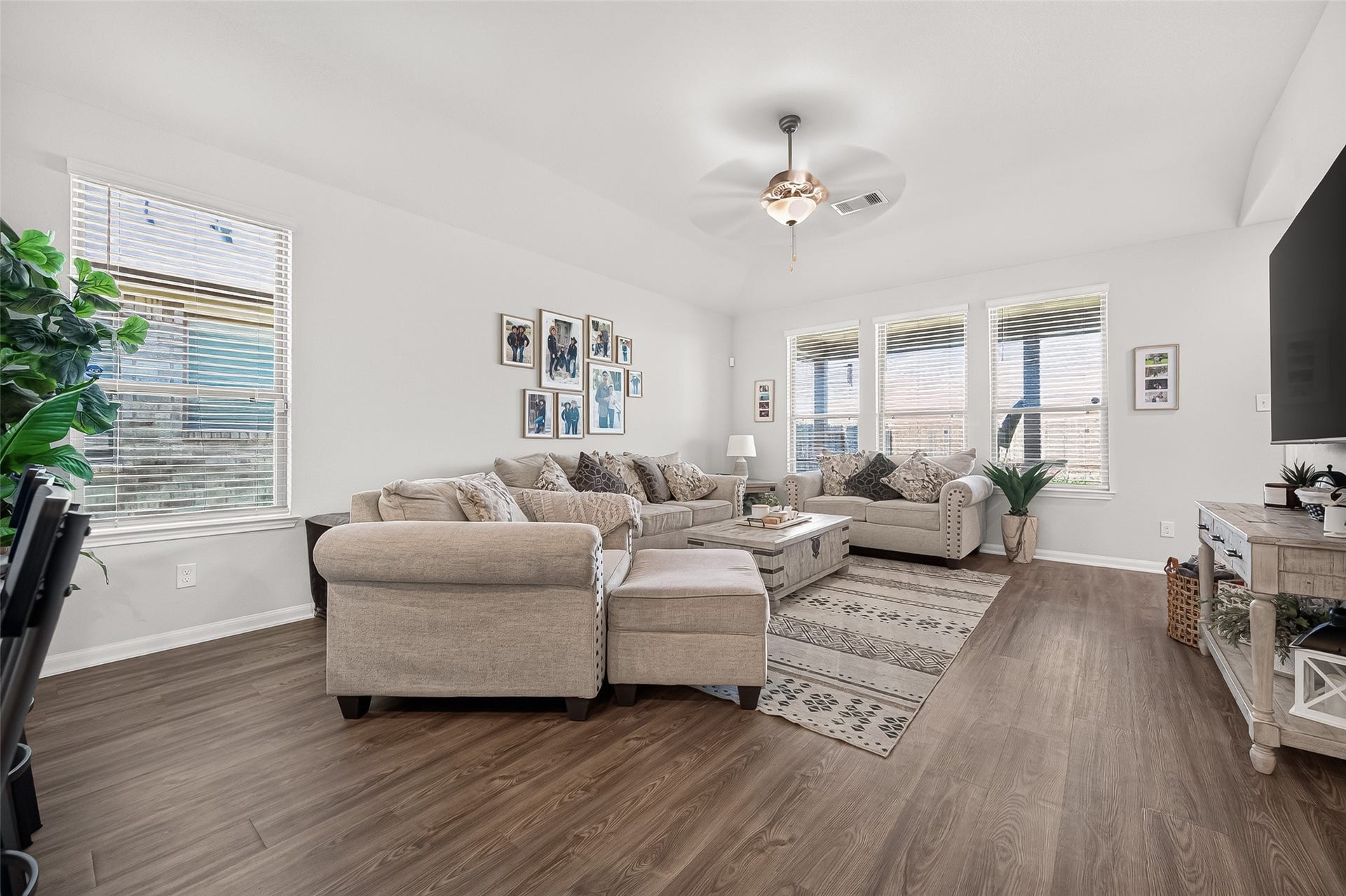 8422 Black Pearl Court, Texas City, TX 77591 Bright and inviting living room with large windows, stylish hardwood floors, and comfortable seating, perfect for relaxation and entertaining.