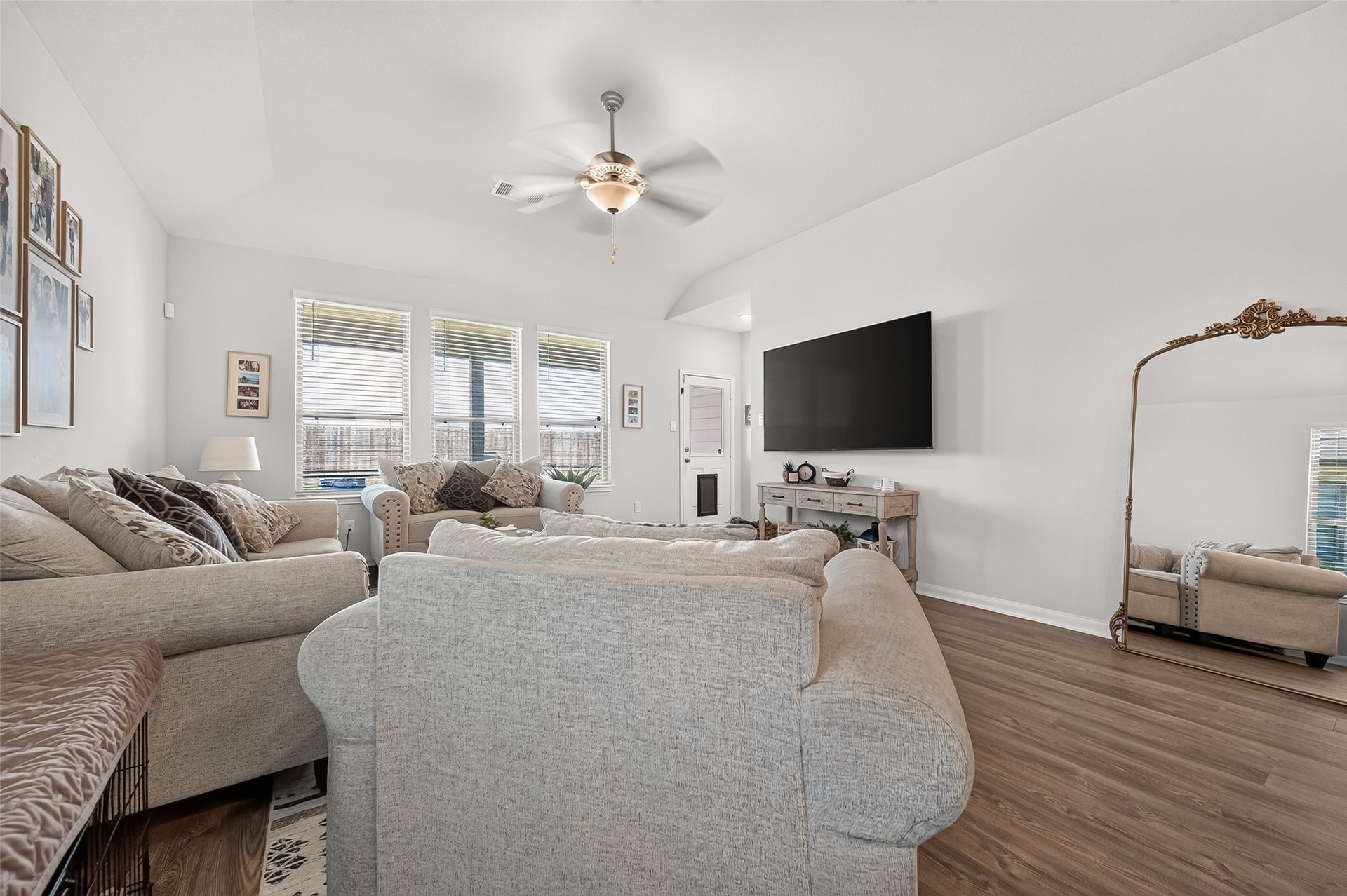 8422 Black Pearl Court, Texas City, TX 77591 Spacious living room with abundant natural light, elegant hardwood floors, and a cozy seating area perfect for relaxation.