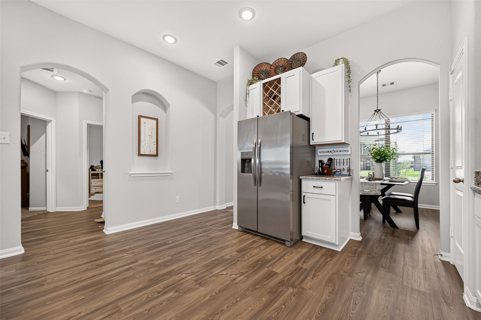8422 Black Pearl Court, Texas City, TX 77591 Modern kitchen with sleek stainless steel appliances, elegant cabinetry, and a charming dining area bathed in natural light.