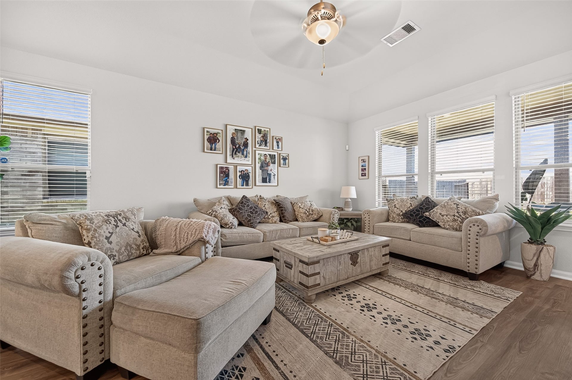 8422 Black Pearl Court, Texas City, TX 77591 Bright and inviting living room with plush seating, a stylish coffee table, and abundant natural light streaming through multiple windows, perfect for relaxation and entertaining.