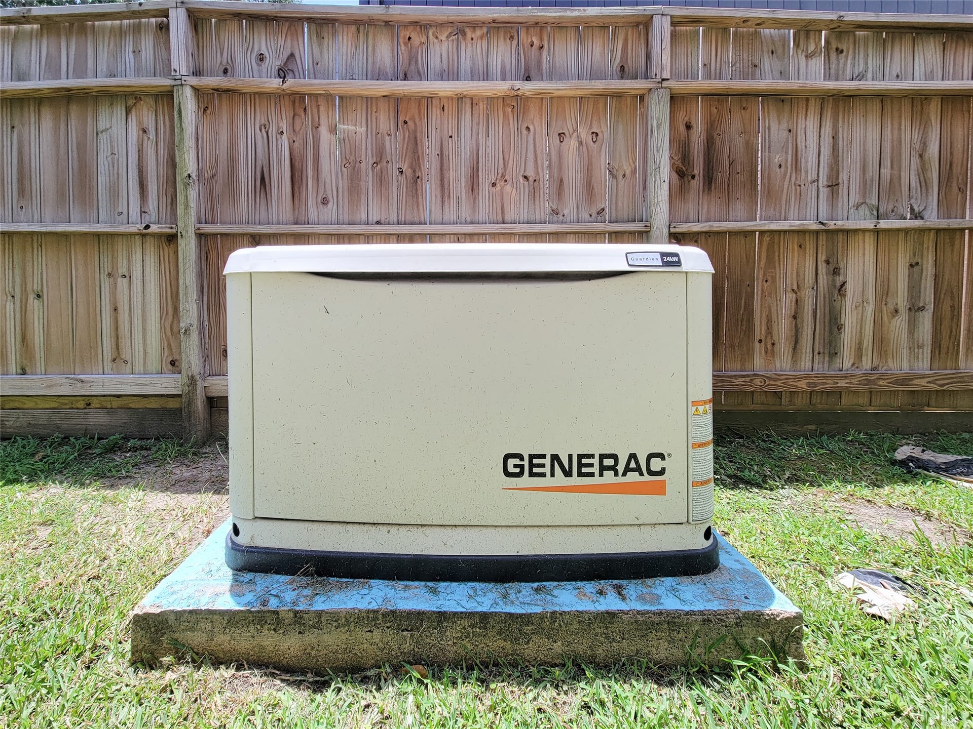 6235 Rolling Water Drive, Houston, TX 77069 This photo shows a Generac standby generator installed on a concrete pad in a backyard, providing backup power capability for the home.