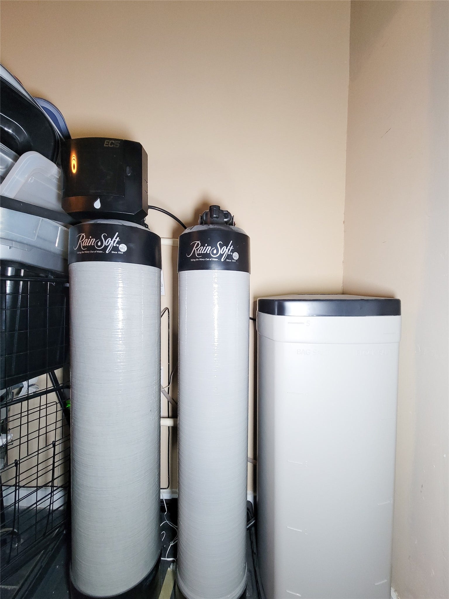 6235 Rolling Water Drive, Houston, TX 77069 Water softening system, including two RainSoft tanks and a brine tank, installed in a utility area.